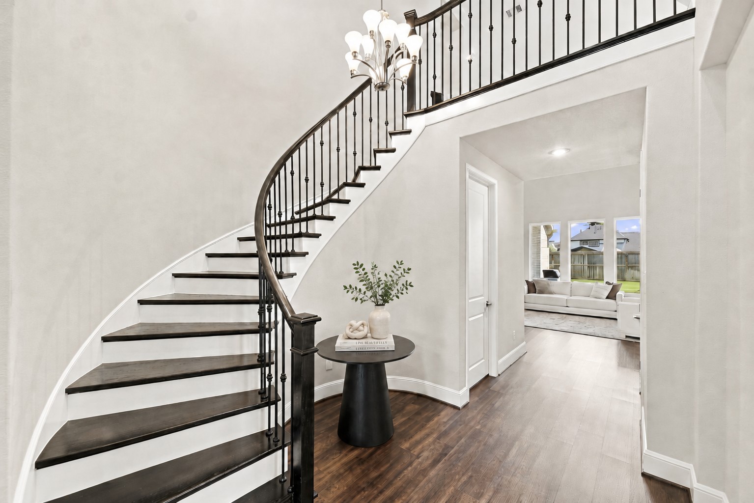 Grand curved staircase and soaring 2-story entry add architectural impact. Grand curved staircase and soaring 2-story entry add architectural impact.