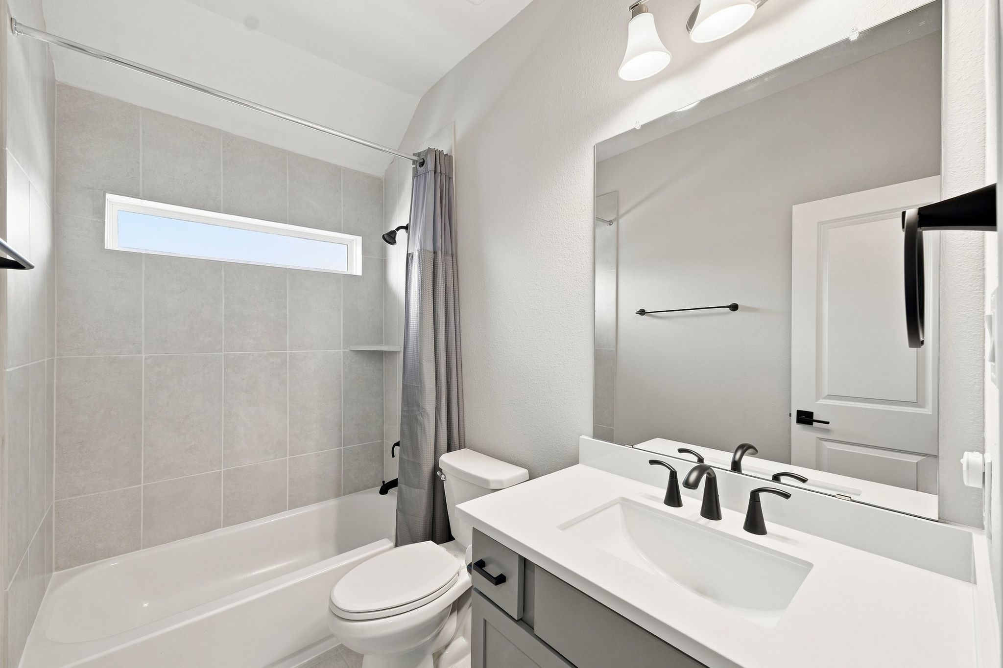 Full bathroom accessible to all on the second floor, but situated between the two bedrooms.