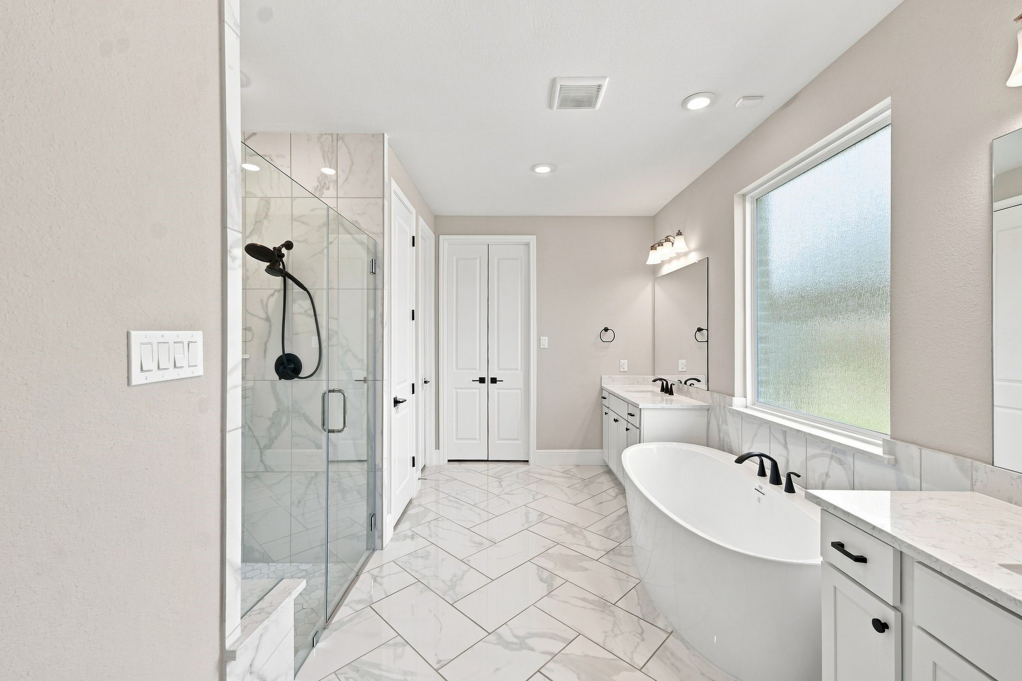 Primary suite bathroom features soaker tub & separate shower, with an oversized closet (accessible through the folding doors), which also connects to the laundry room! Primary suite bathroom features soaker tub & separate shower, with an oversized closet (accessible through the folding doors), which also connects to the laundry room!
