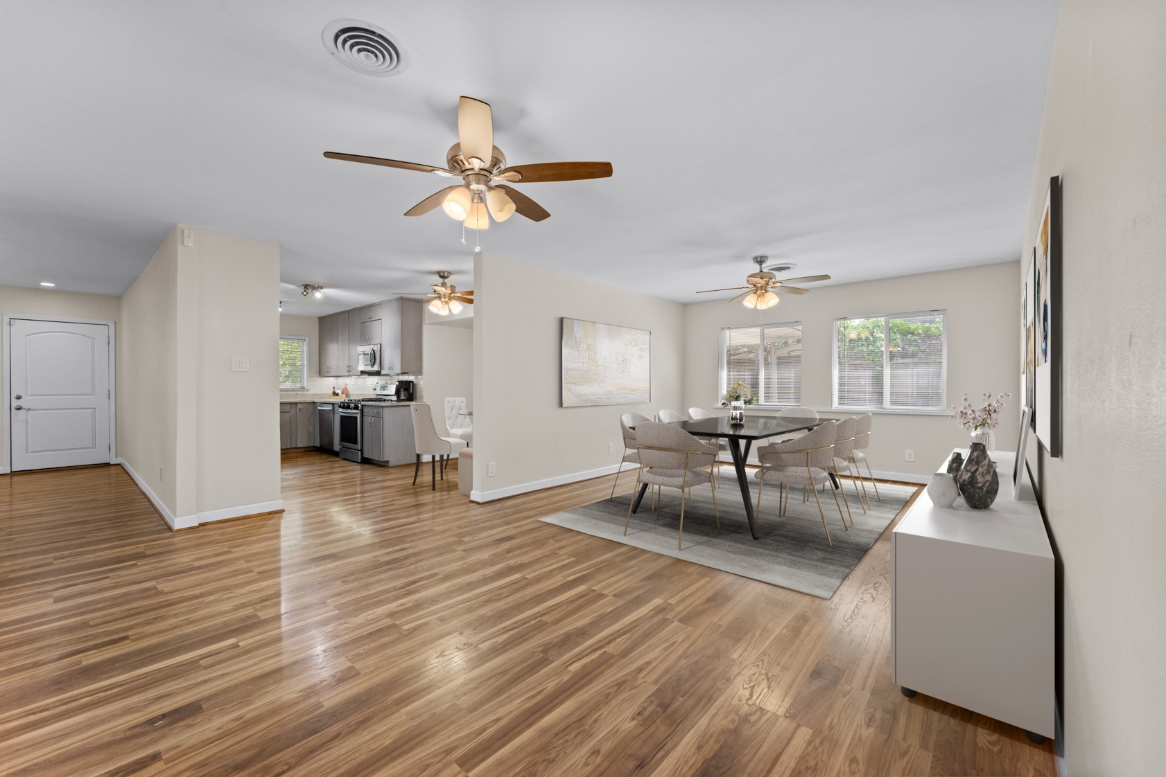 Virtually staged as a dining room.  Windows abound on both sides of this room!