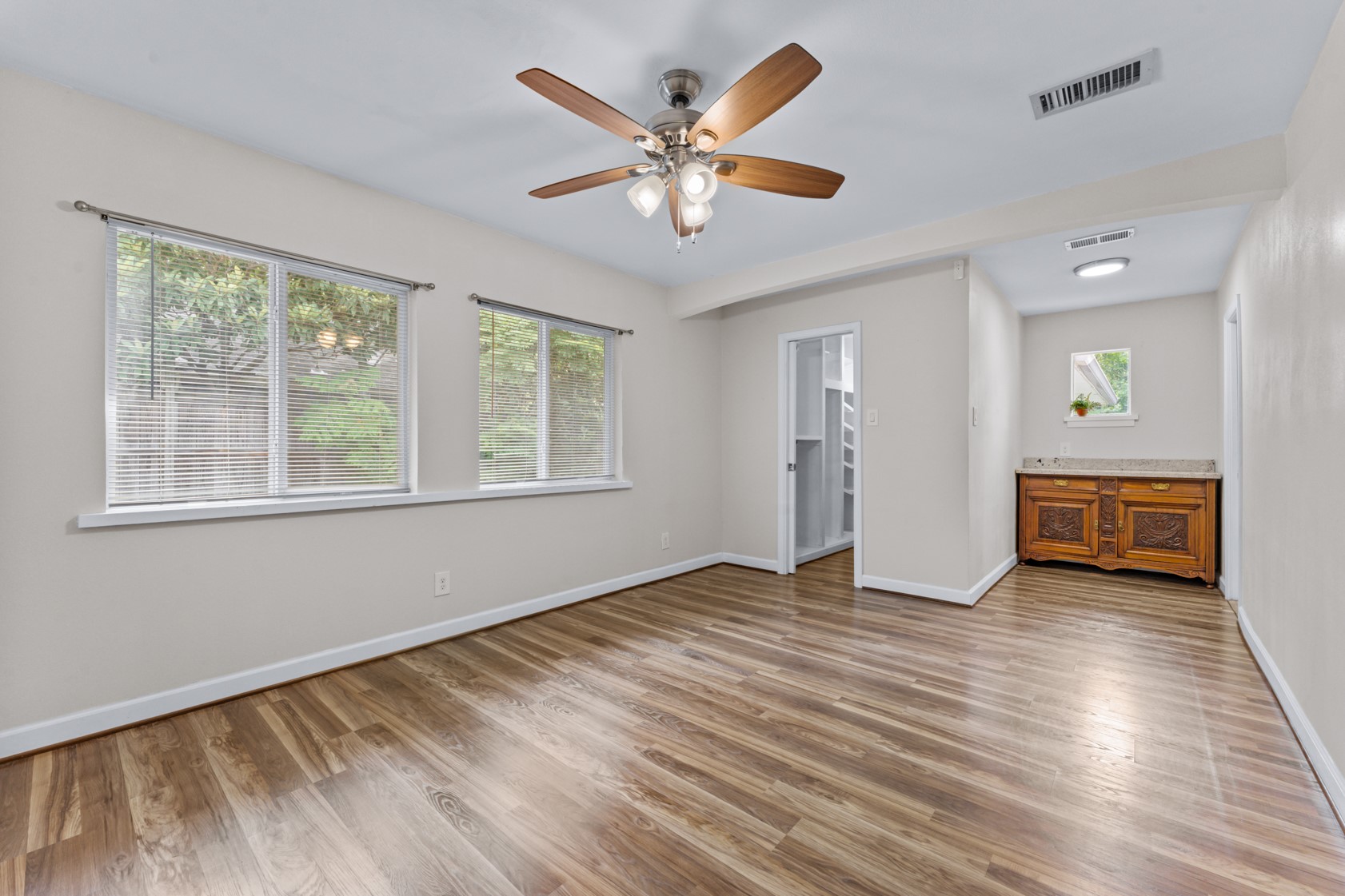 The primary suite includes TWO closets - one shown in this photo - built-in storage, and a beautiful primary bathroom.