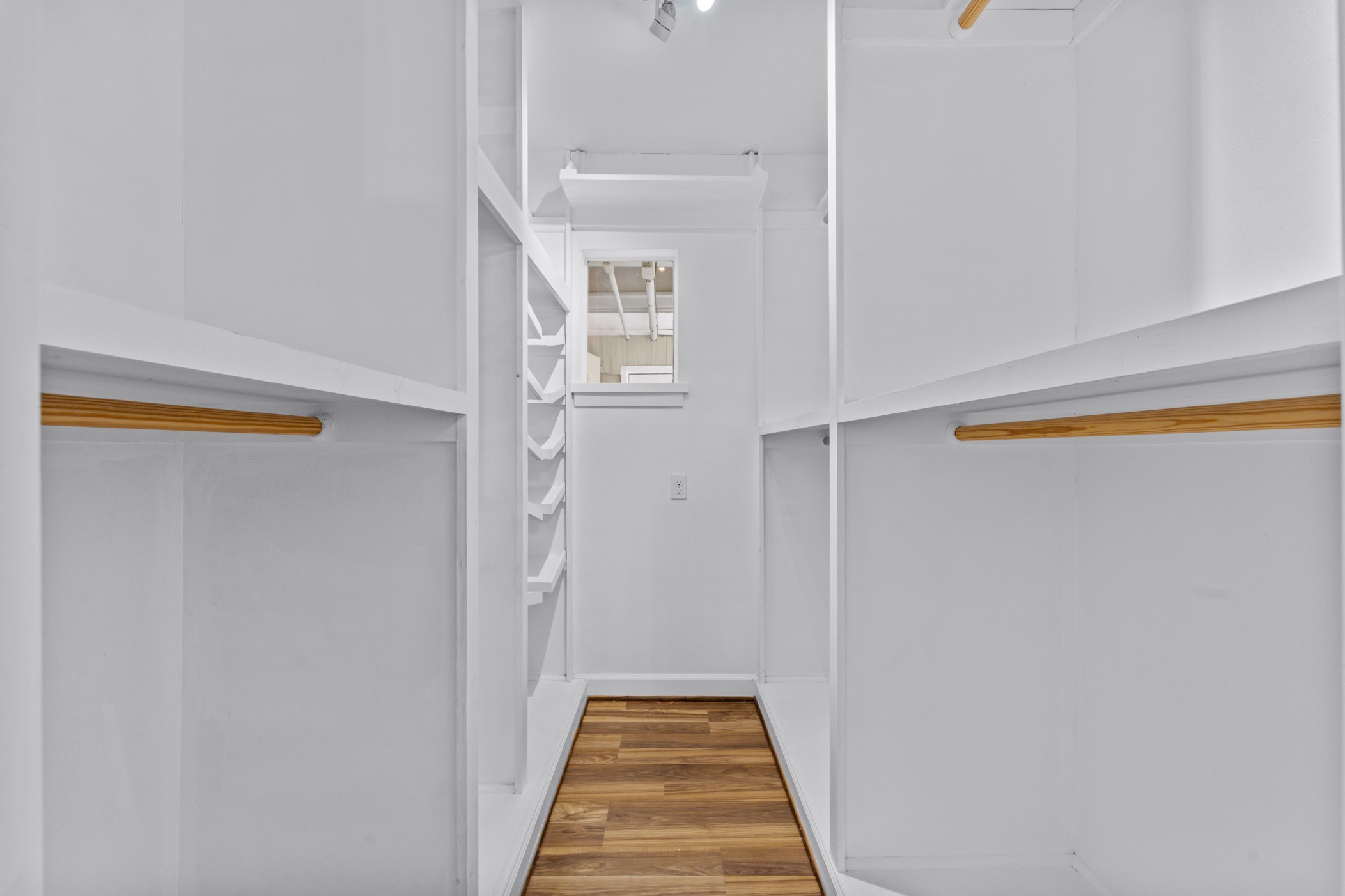 This walk-in closet is the larger of the two closets in the primary suite. Enjoy easy organizing with built in shelves!