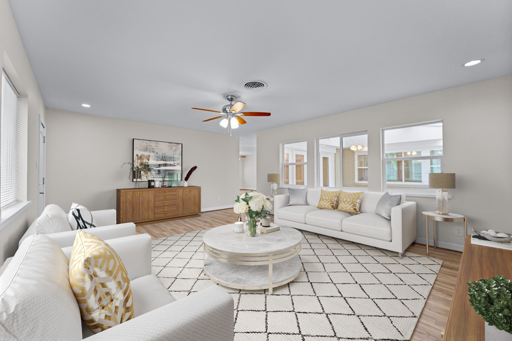 With windows on two sides of this living area, natural light fills the room at various times throughout the day.  Virtually staged photo.