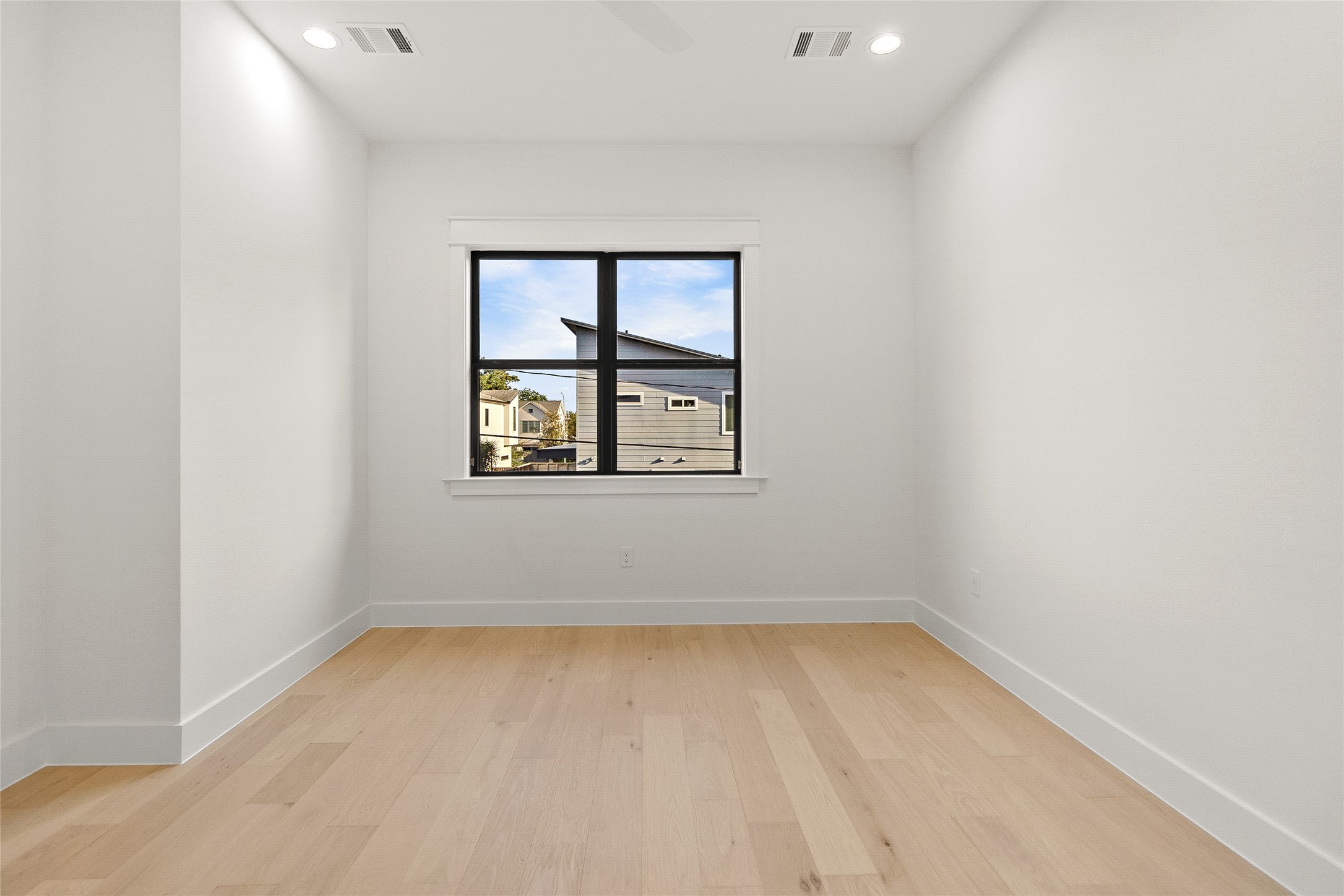 Natural light fills your second secondary bedroom, creating a comfortable space that's ready to become your guest room, second office, or creative space.