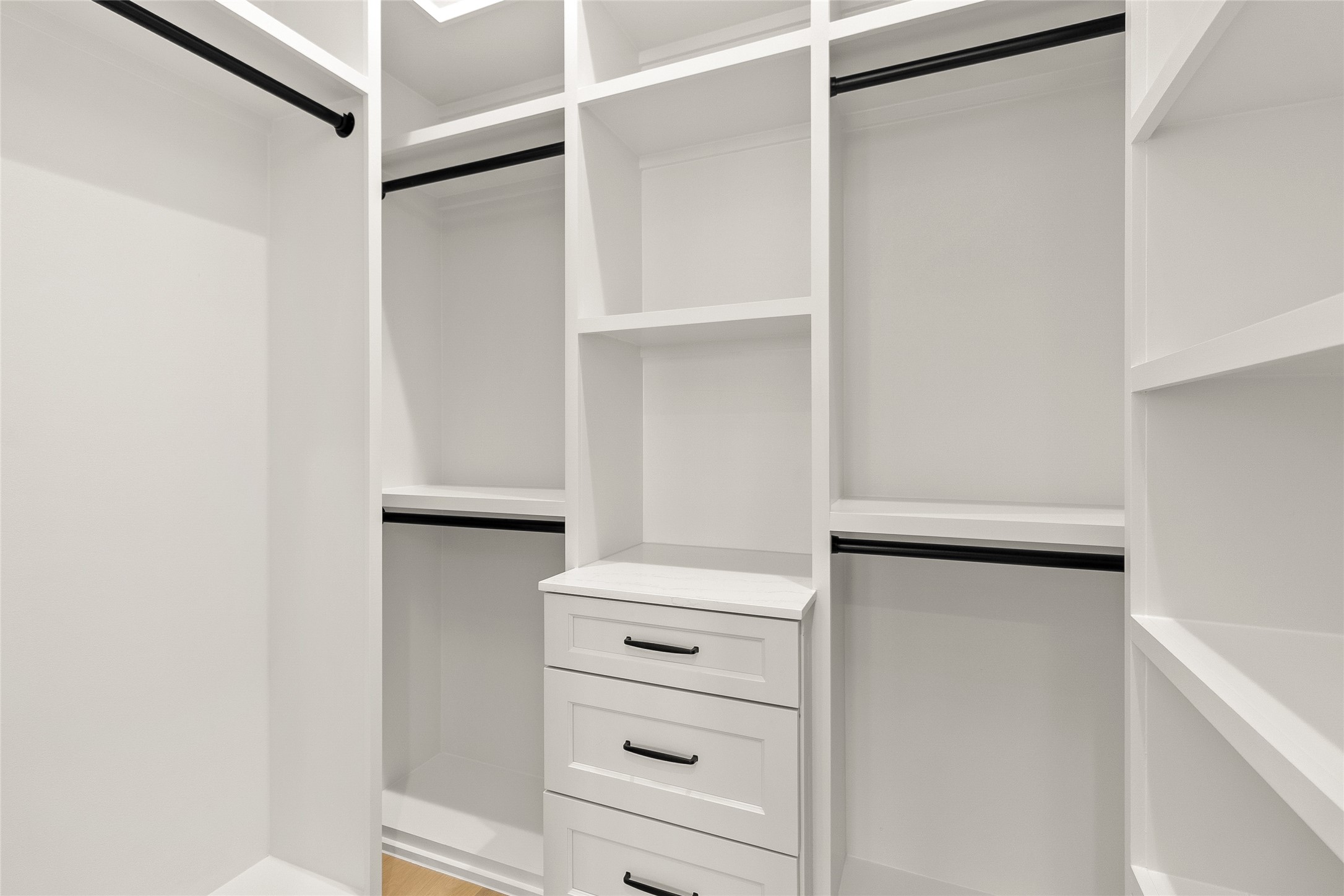 Your custom walk-in closet keeps every wardrobe essential beautifully organized with built-in shelving, drawers, and generous hanging space.