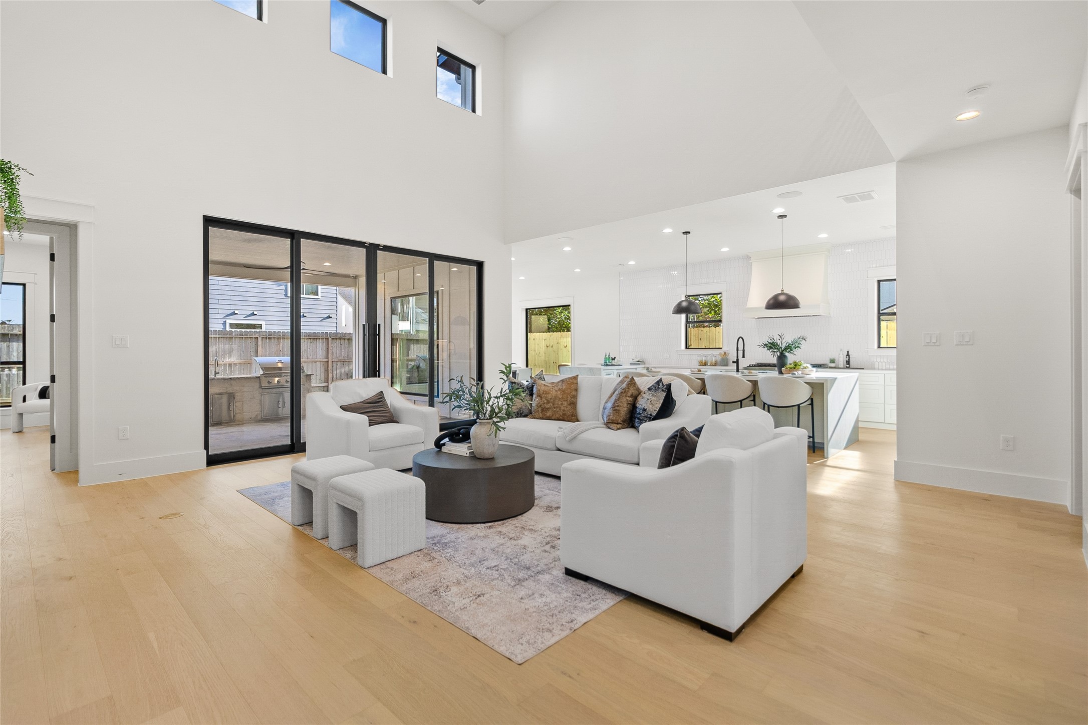 Everyday living feels effortless in this soaring open-concept space, where natural light, seamless indoor-outdoor flow, and designer details create the perfect gathering place.