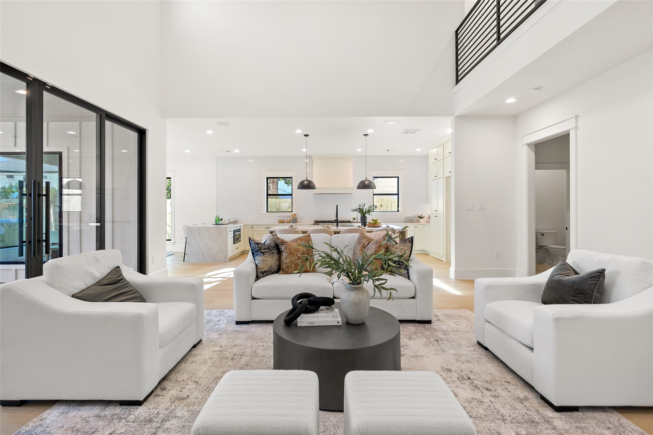 Everyday living flows effortlessly through this bright open-concept layout, where soaring ceilings, expansive windows, and seamless connections create a home that feels both spacious and welcoming. Everyday living flows effortlessly through this bright open-concept layout, where soaring ceilings, expansive windows, and seamless connections create a home that feels both spacious and welcoming.