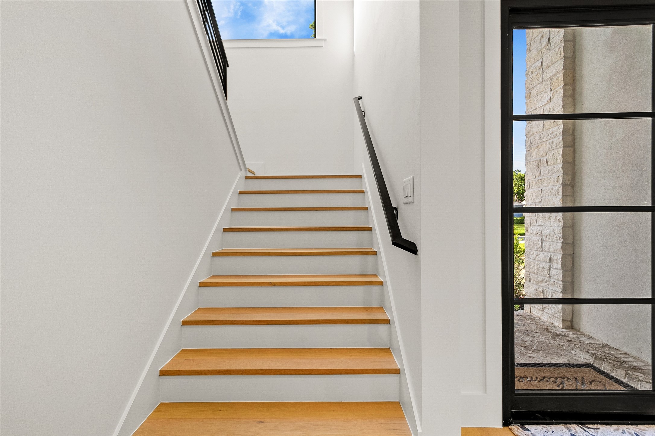 Every trip upstairs welcomes you with clean architectural lines, abundant natural light, and beautifully crafted wood stairs that connect each level with style.