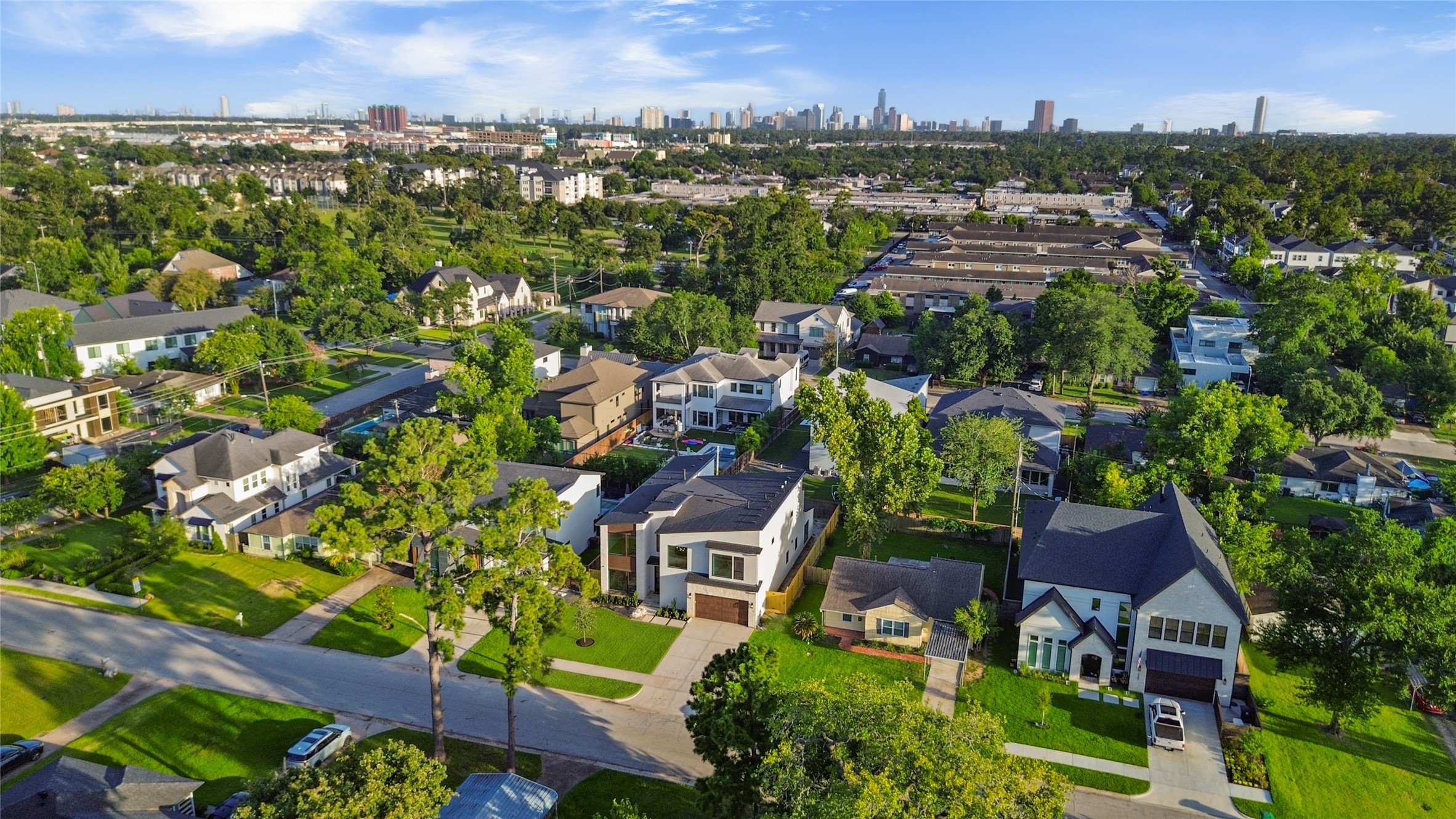 Aerial views highlight your home's prime location with easy access to nearby parks, shopping, dining, and the Houston skyline just beyond.