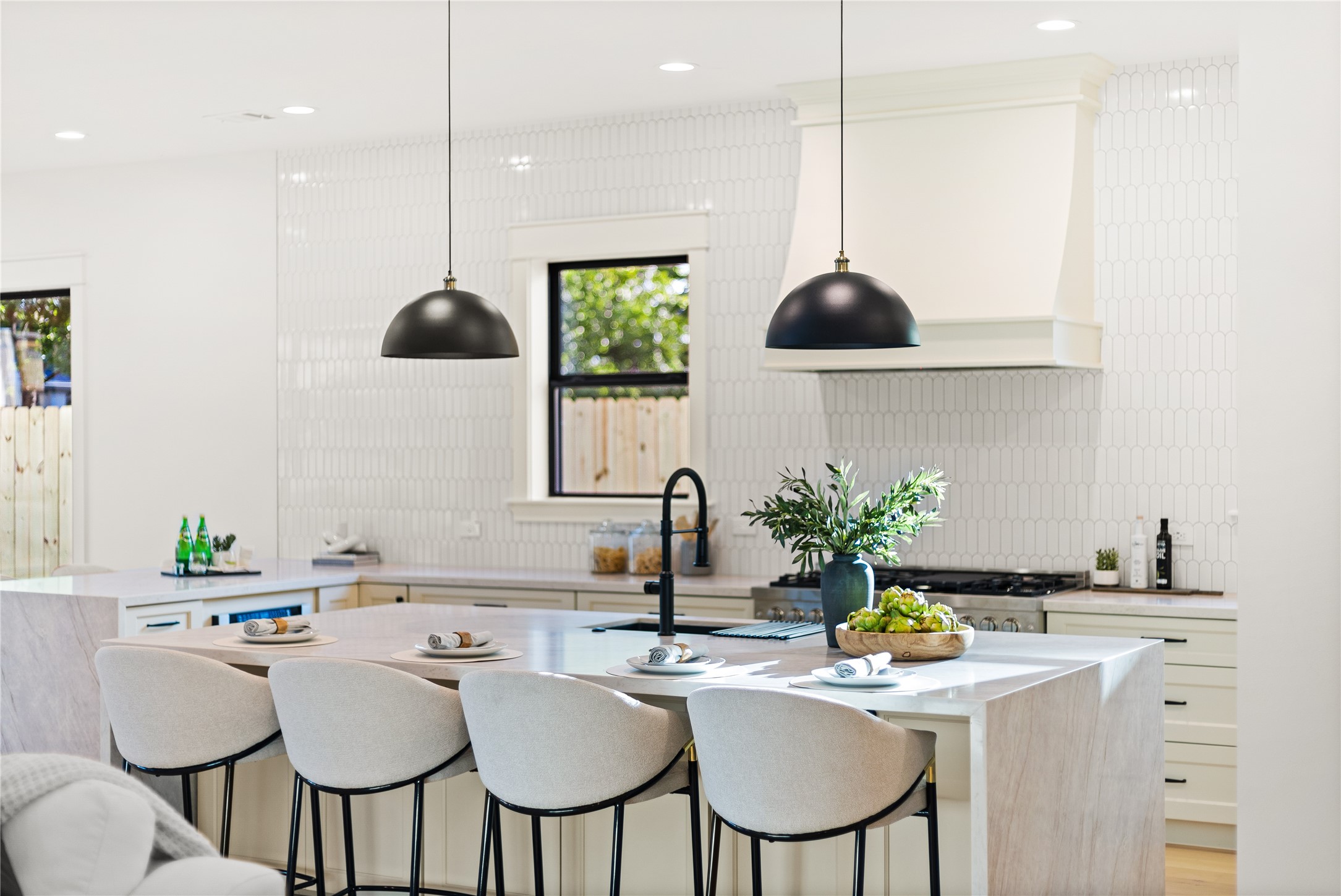 Gathering around the oversized island becomes the heart of every day, where sleek finishes, designer lighting, and generous prep space elevate every occasion.