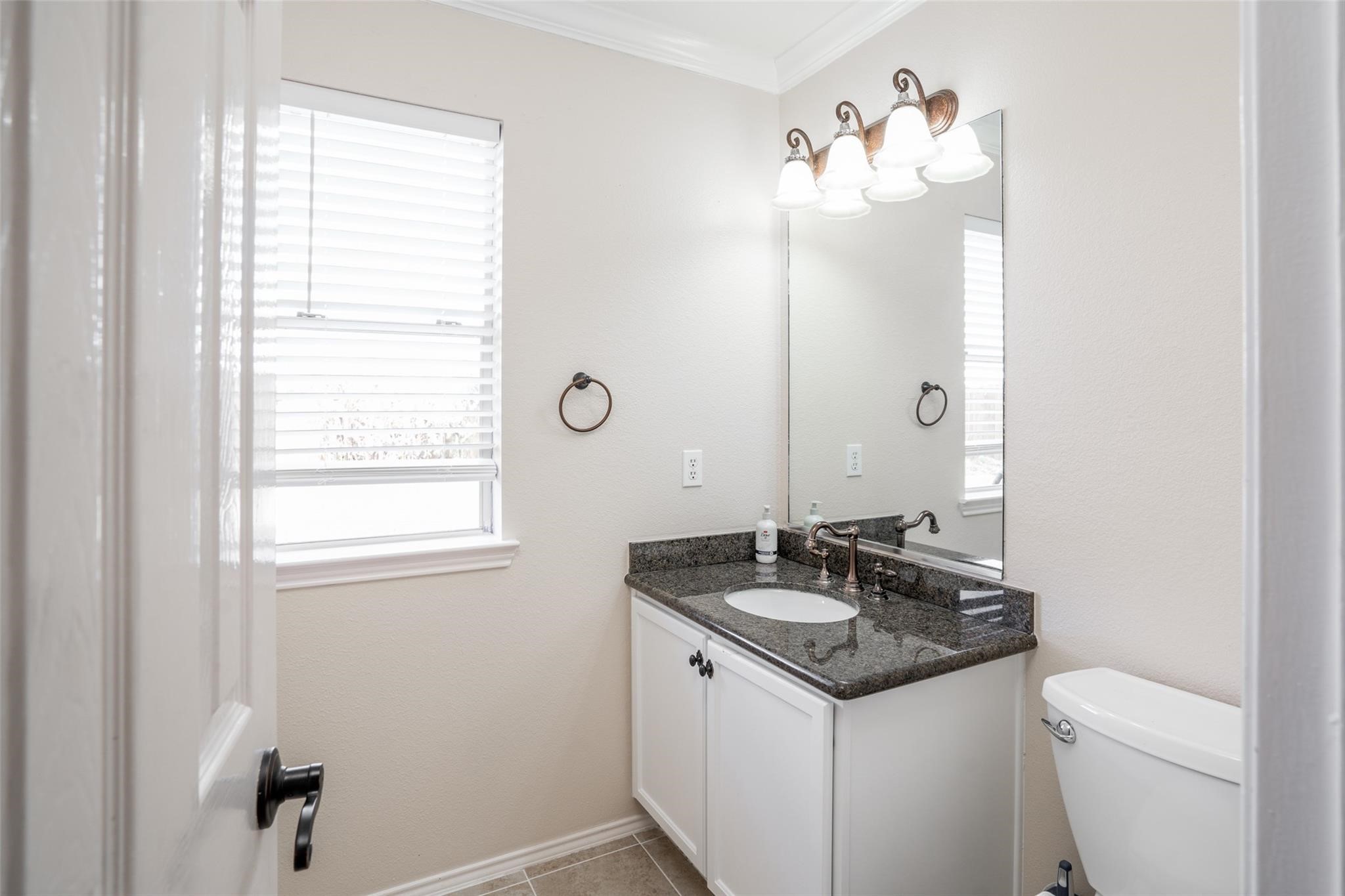 A convenient half bath is tucked away at the back of the home!