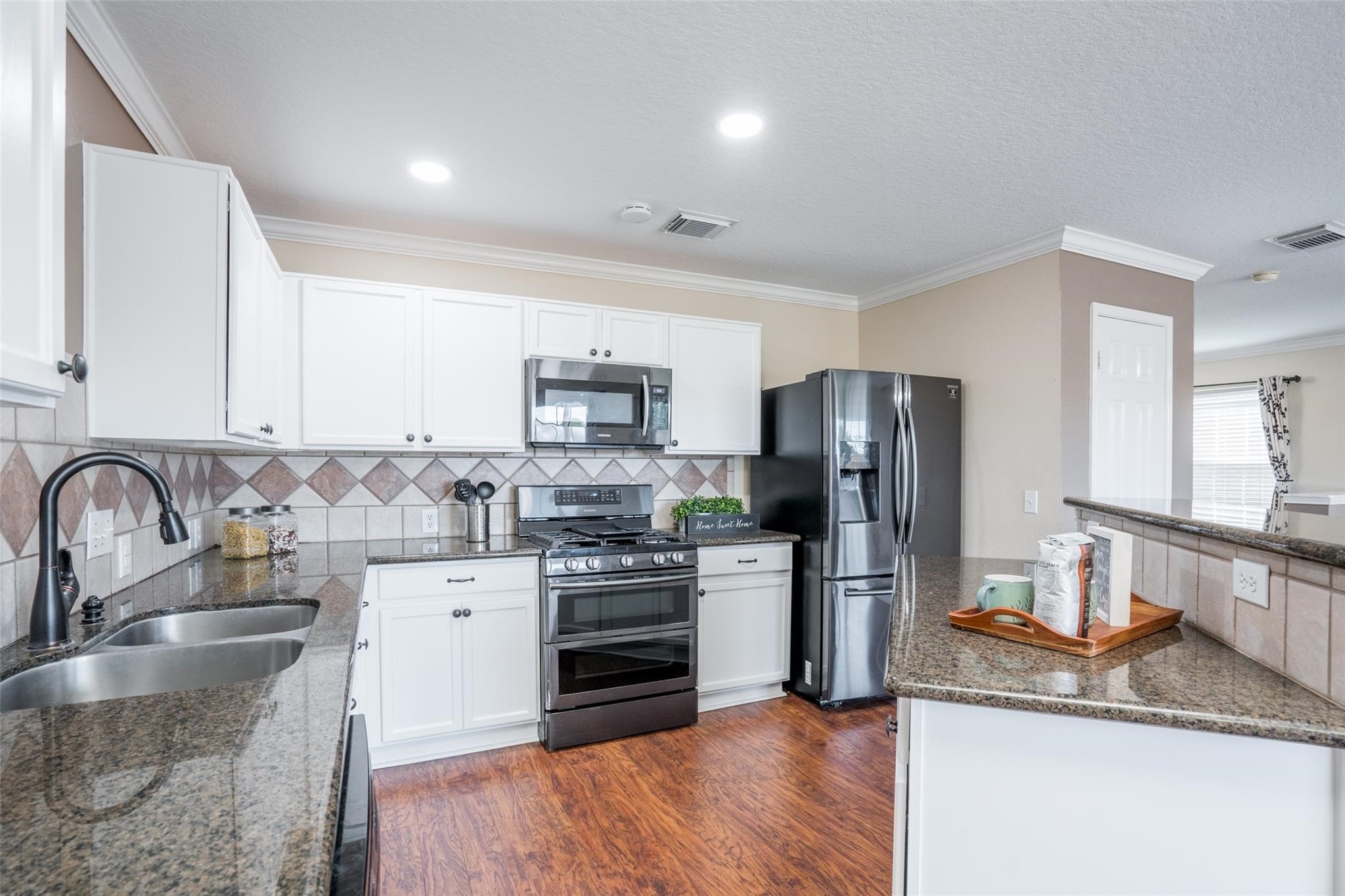 Crisp white cabinets and modern appliances are hallmarks of this cozy kitchen! Prep your gourmet meals with plenty of counter space! Crisp white cabinets and modern appliances are hallmarks of this cozy kitchen! Prep your gourmet meals with plenty of counter space!