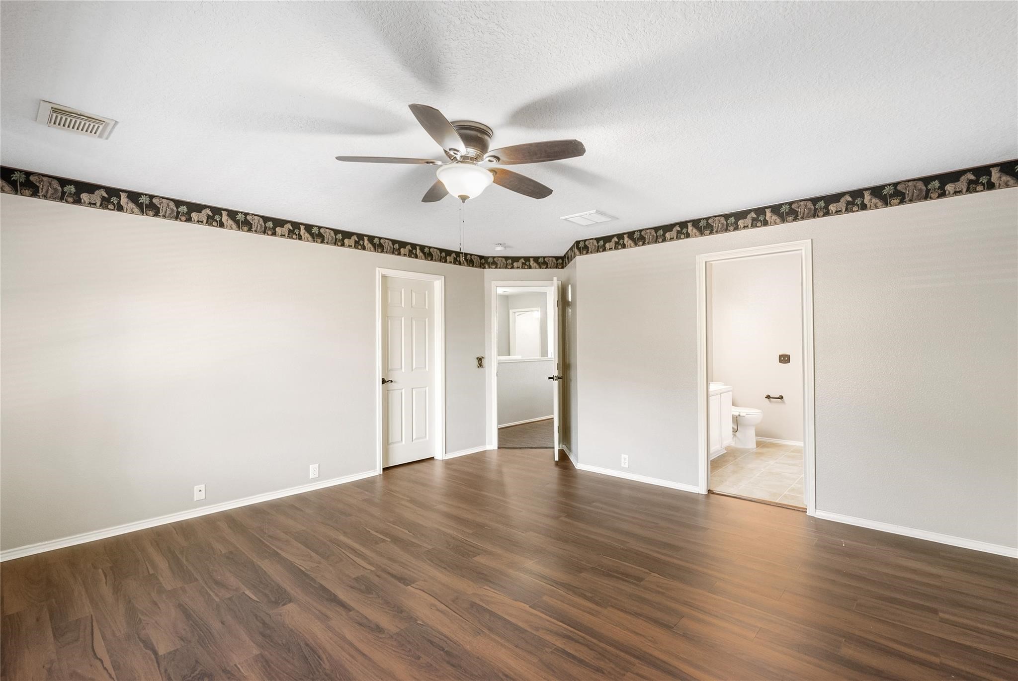 There is plenty of space for your personal items in this enormous primary bedroom.