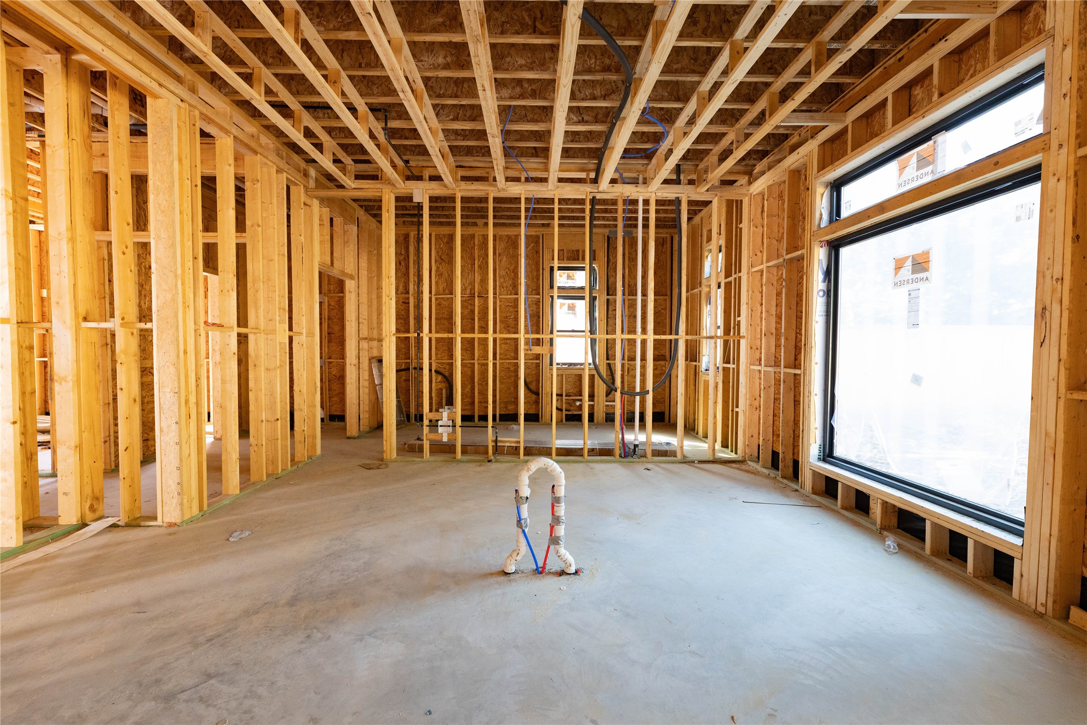 Chef's Kitchen features a large waterfall edge quartz island, full thermador appliance package including 48" gas range, 48" fridge, built-in coffee maker & Scullery located directly behind the Kitchen w/ 2nd Fridge & dishwasher. Construction Photo taken 10/22/26