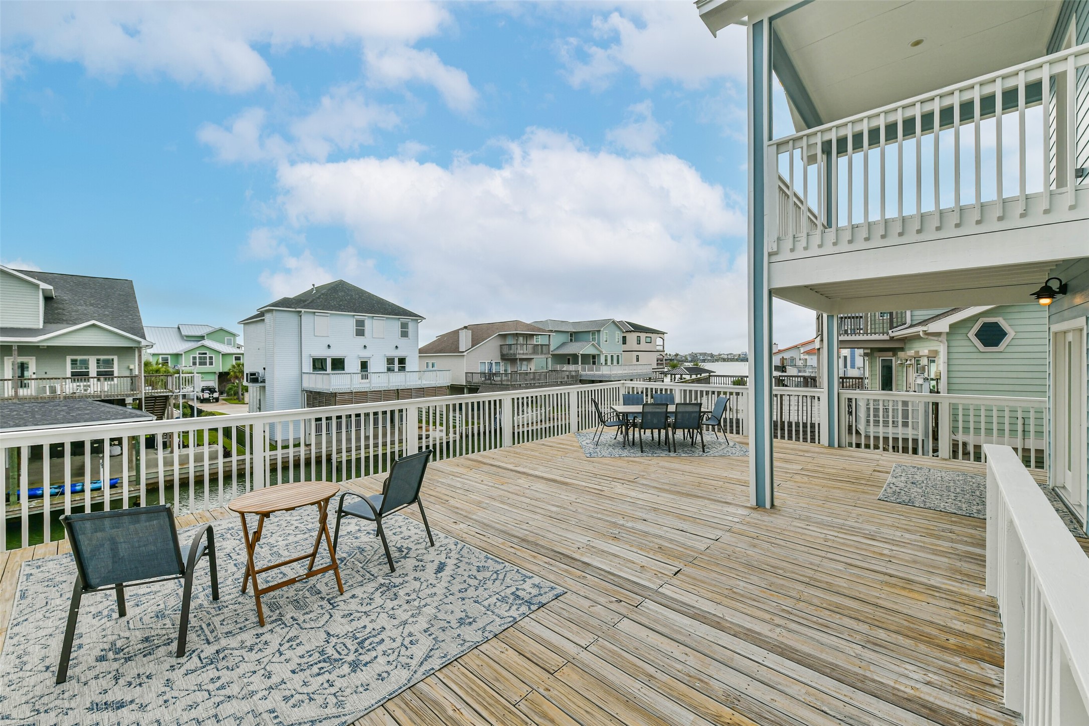 Spacious outdoor deck offers relaxing canal views and a blend of sun and partial shade, ideal for enjoying coastal breezes and outdoor gatherings.