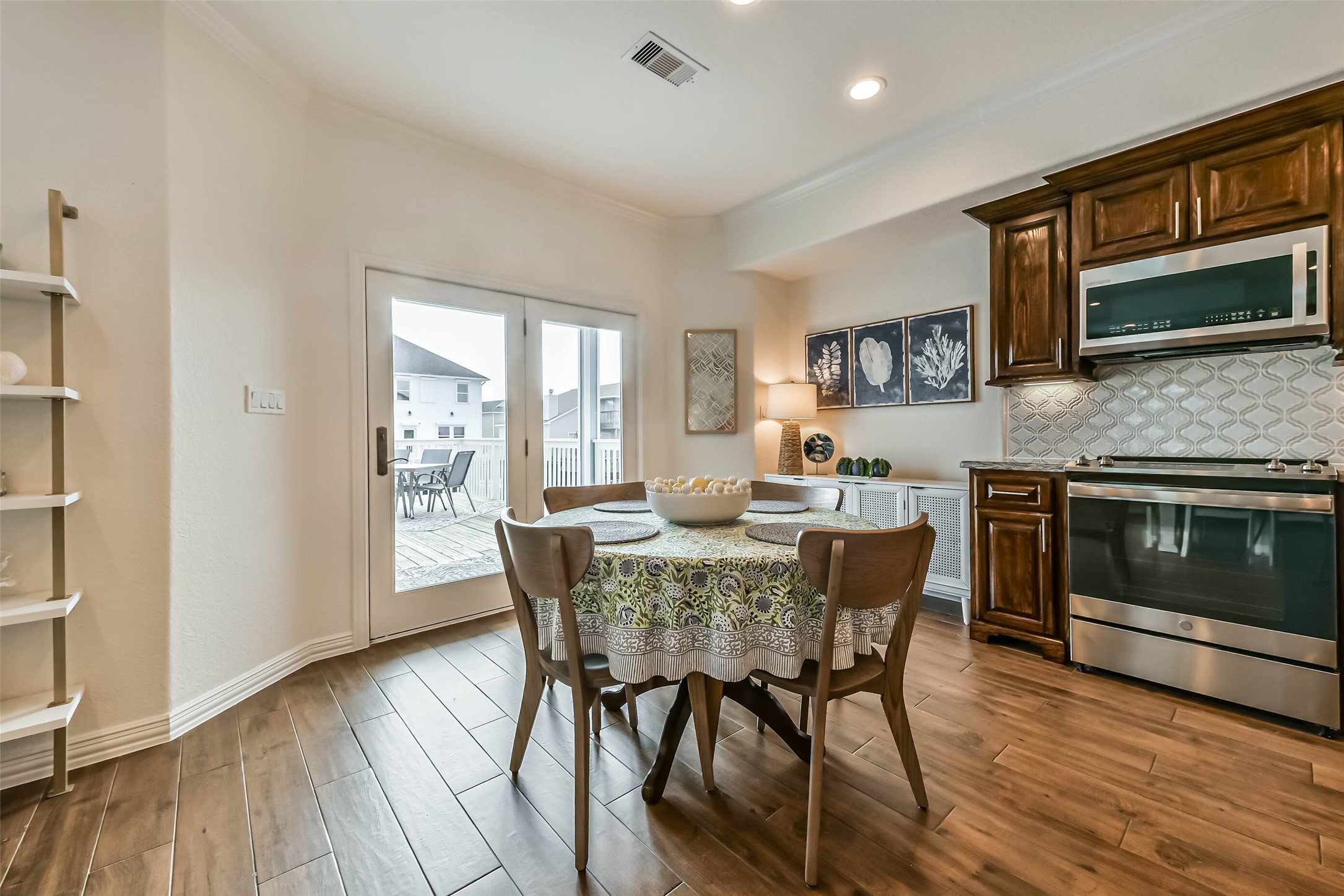 Charming breakfast space positioned beside double glass doors that open directly to the outdoor patio, creating seamless indoor-outdoor living.