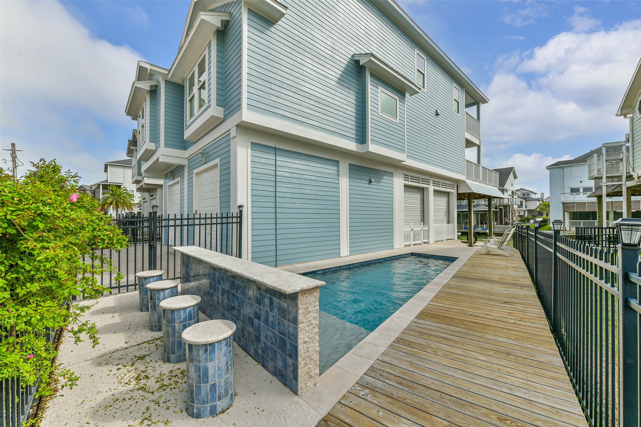 Private pool designed for relaxation and entertaining, featuring a shallow sun shelf perfect for in-water lounging and enjoying coastal breezes.