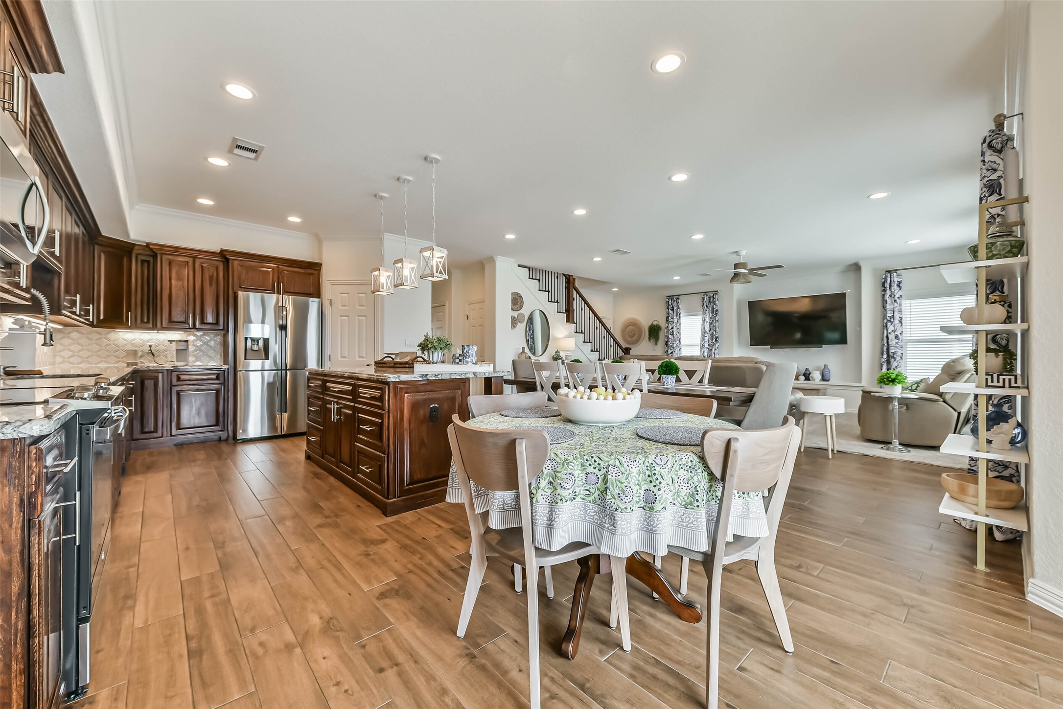 Open-concept design connects kitchen, dining, and living areas for effortless entertaining.