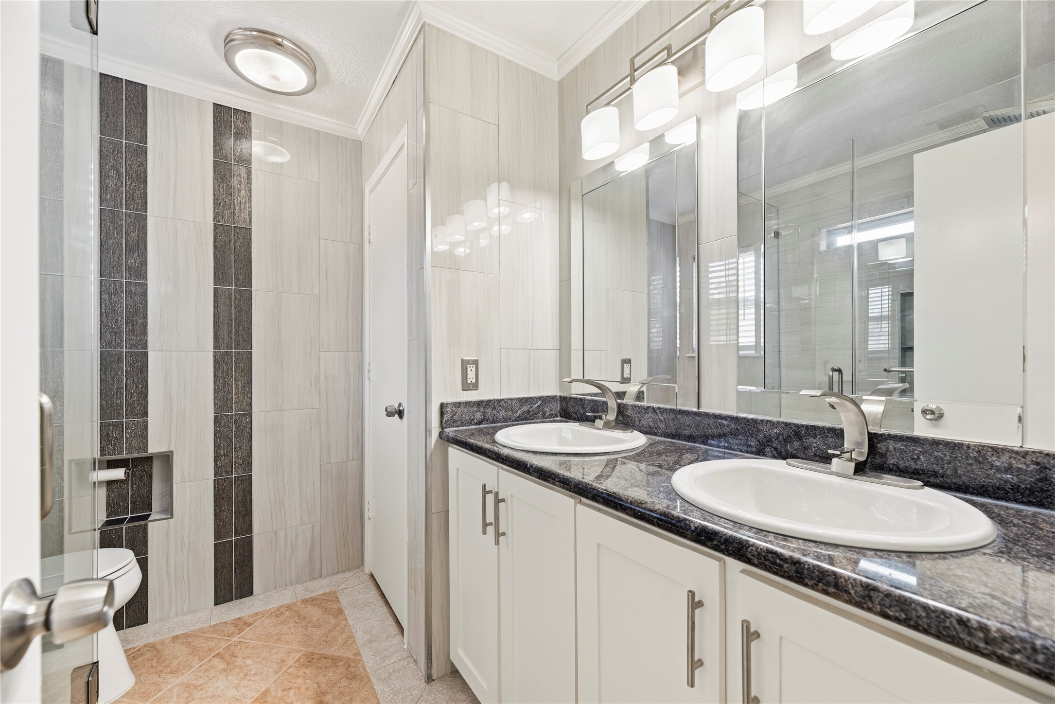 Updated primary bathroom with a dual sink vanity.