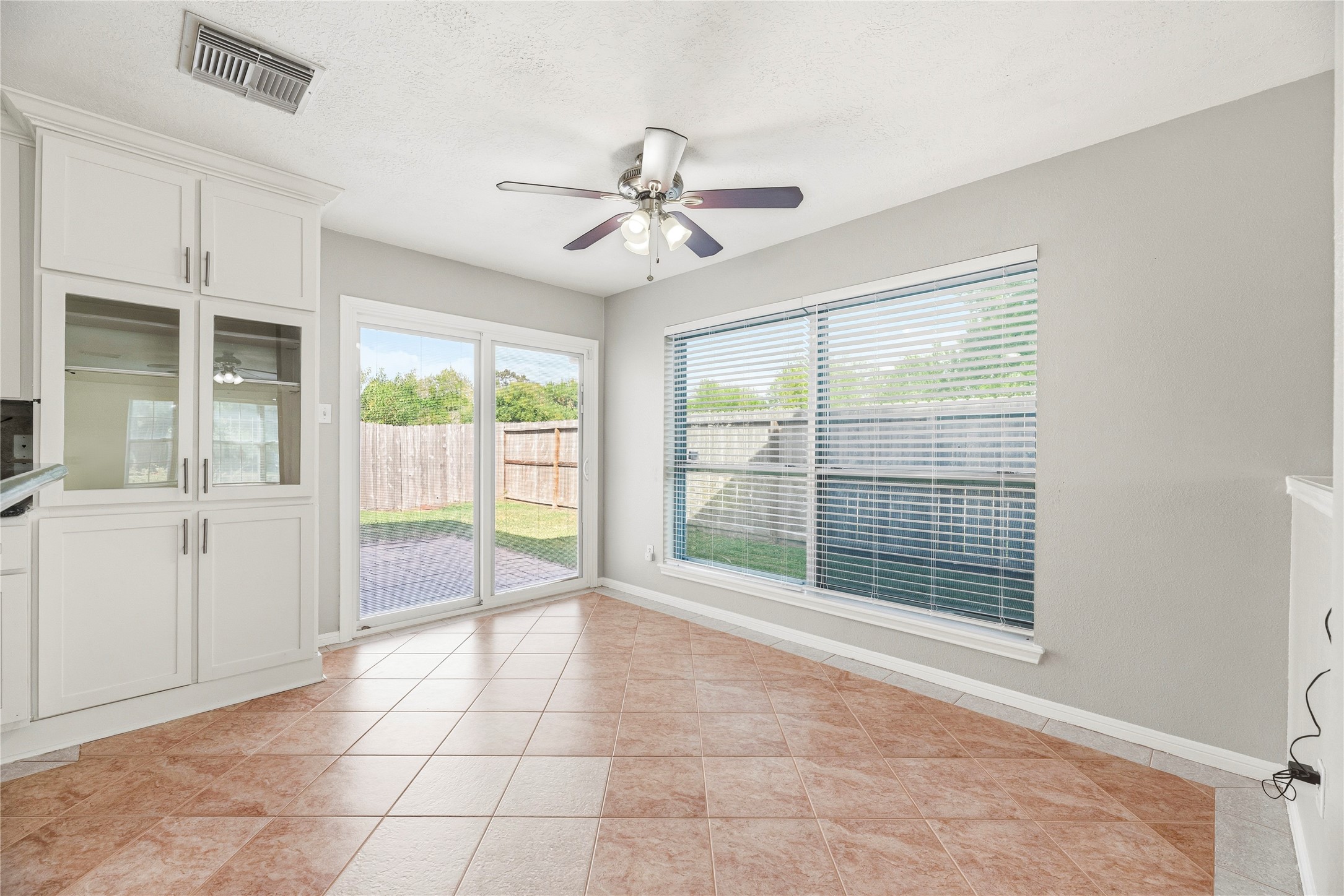 Breakfast area off the kitchen with backyard access.