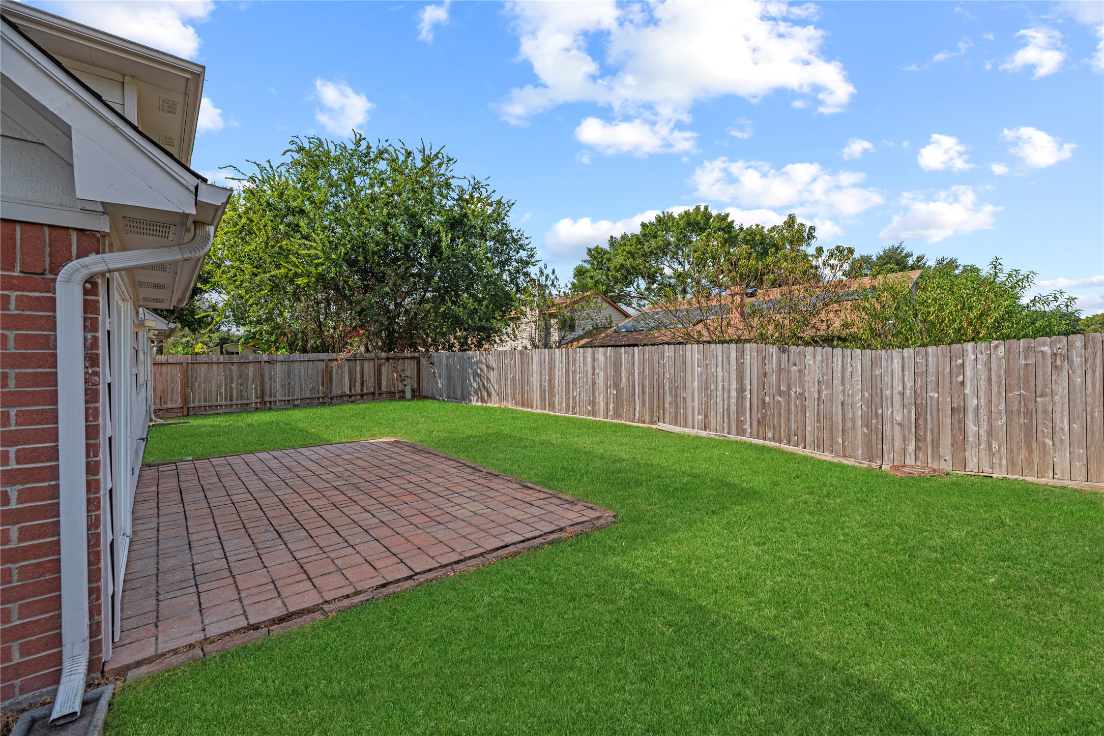 Step outside to a private backyard with a patio area. Grass has been digitally enhanced to show potential.