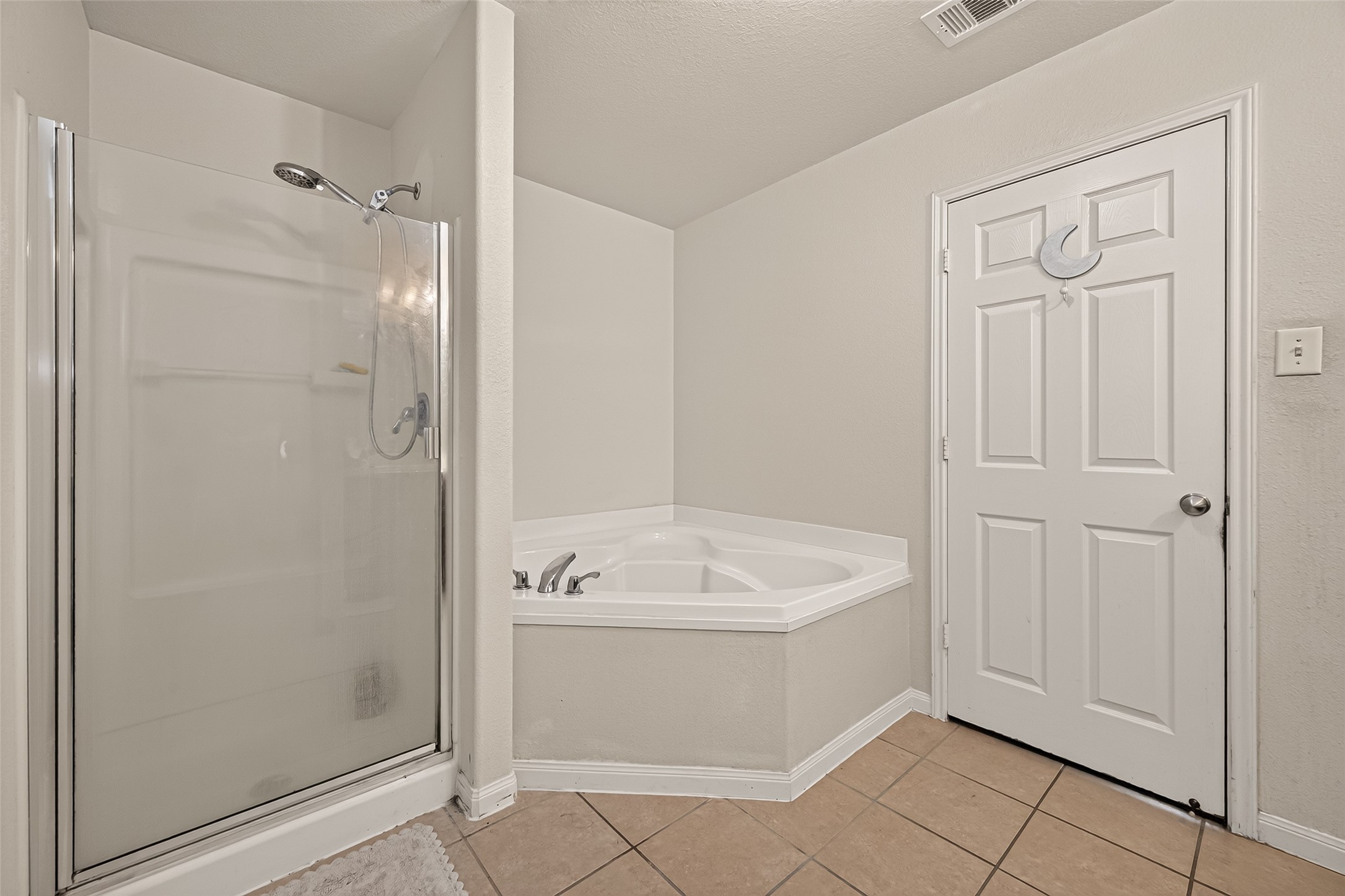 Primary bathroom w/ bath and walk in shower.