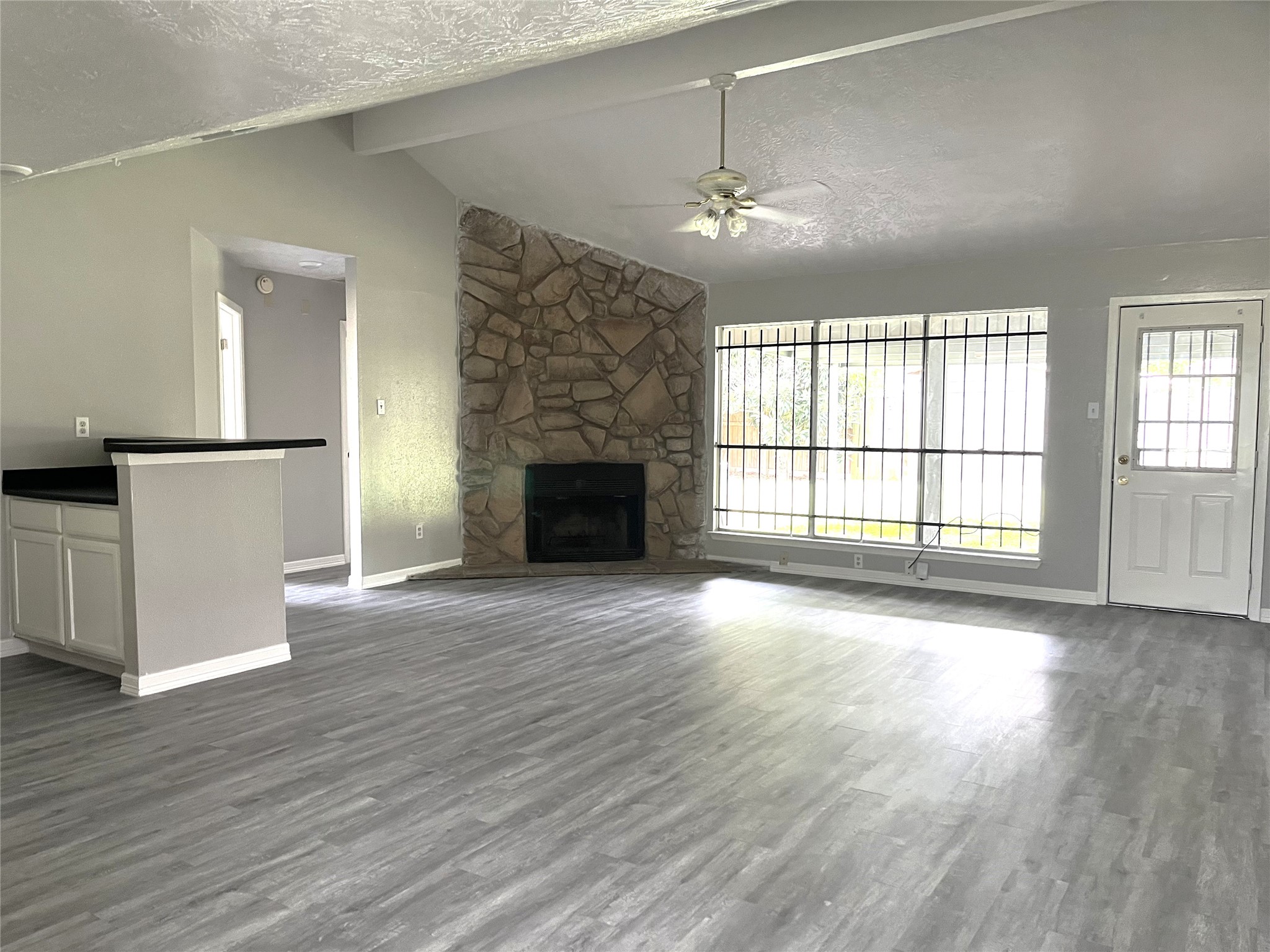 Living area with vaulted ceilings, fireplace and dry bar