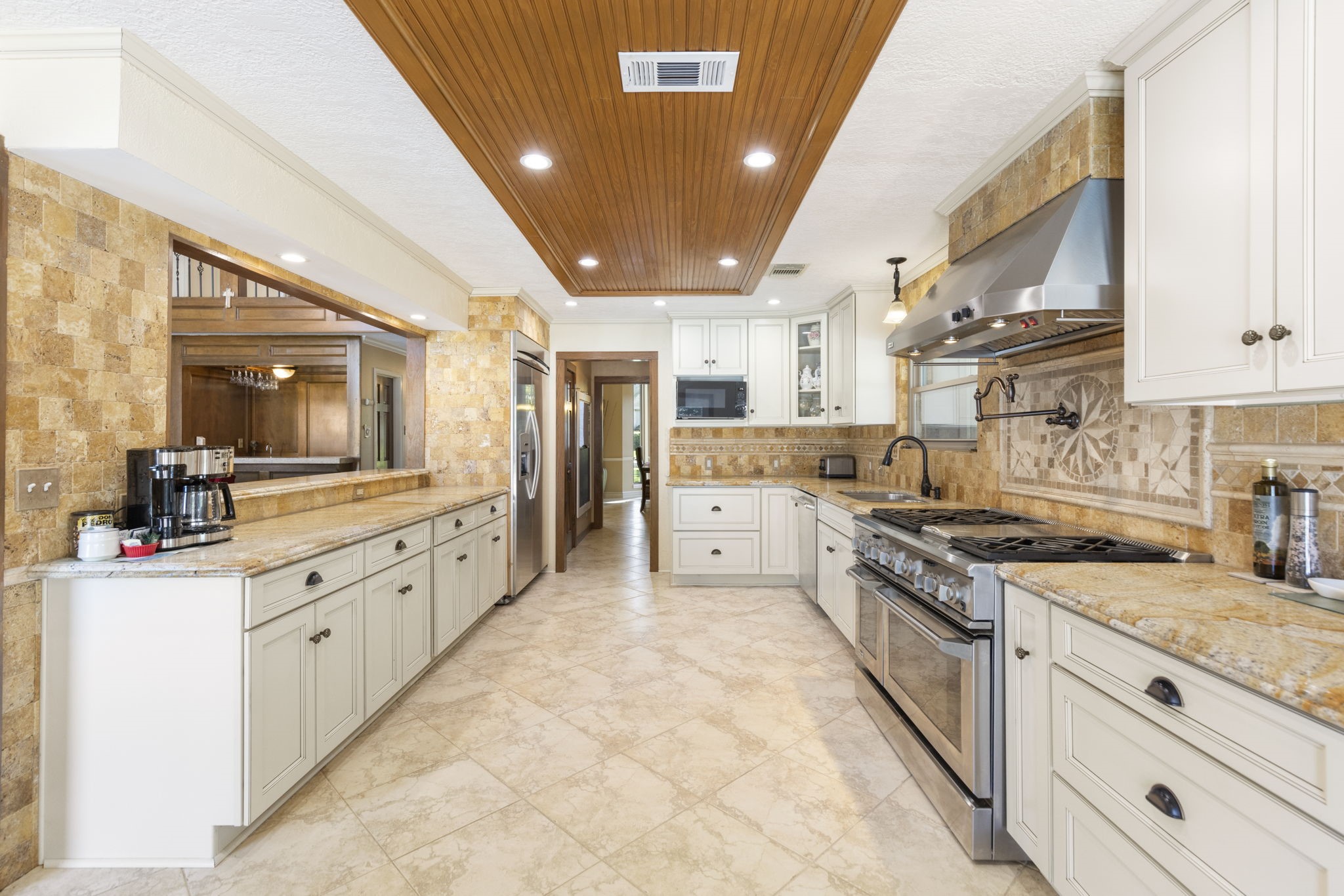 The kitchen provides access to the formal dining room, huge utility room, 2-story den and backyard access.