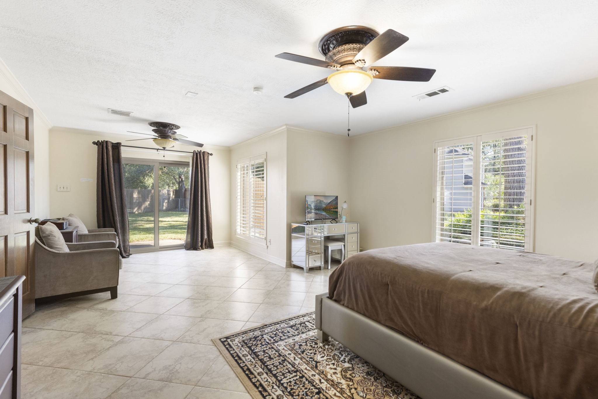 Primary suite privately tucked away on the 1st floor features private nature views and backyard access.