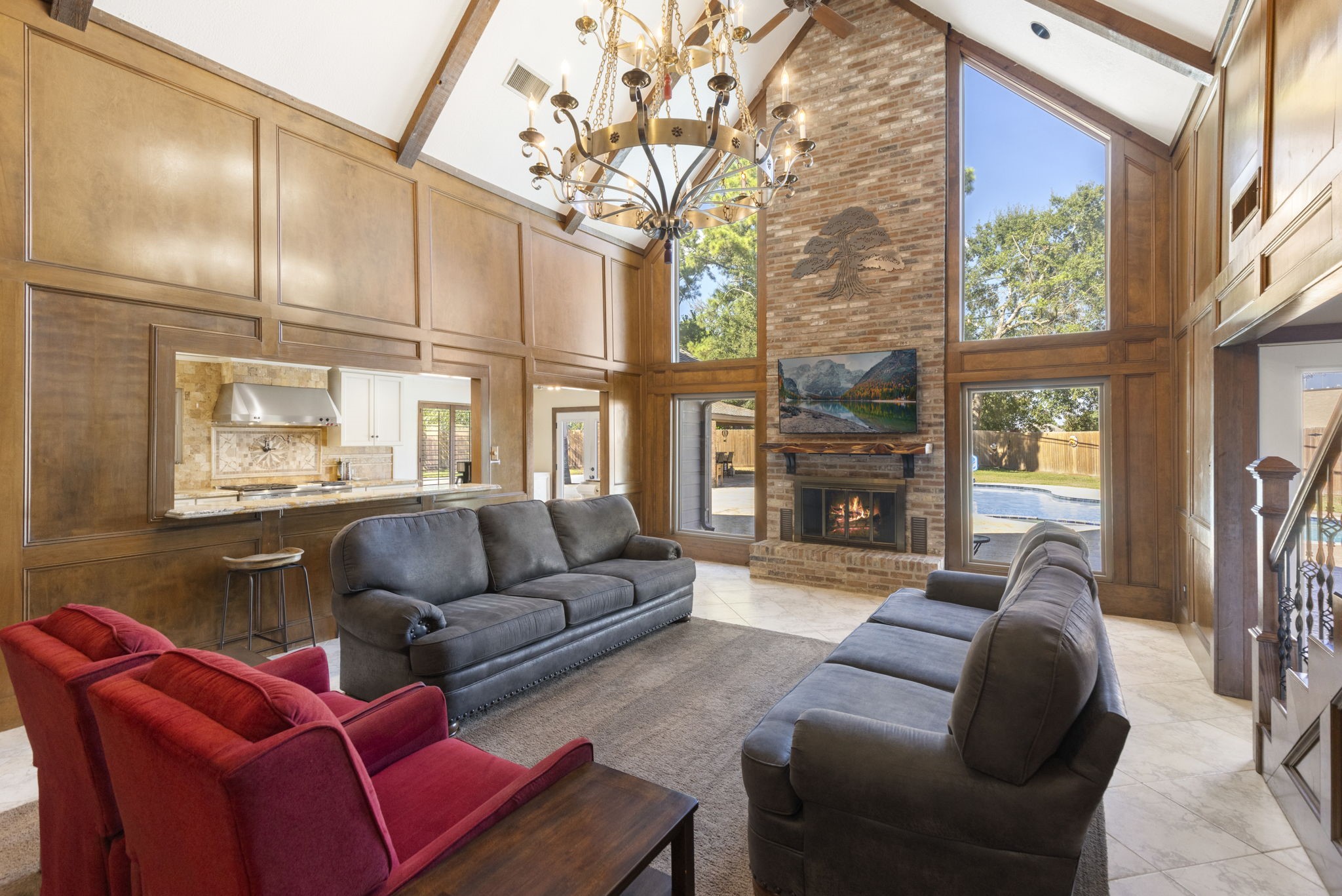 Dramatic 2-story den with floor to ceiling windows creating breathtaking views of the backyard.