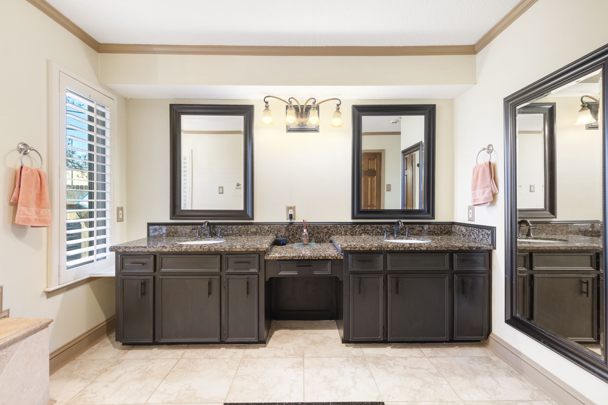Double vanities, granite counters, plantation shutters and full length mirror.
