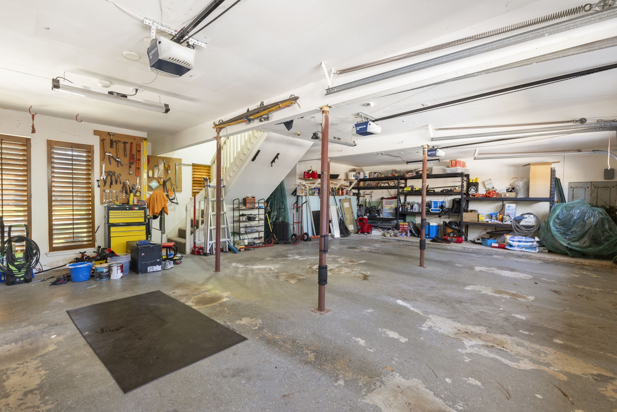 This huge garage, with unique staircase leading to the gameroom, has so many possibilities for the handy person in the family.