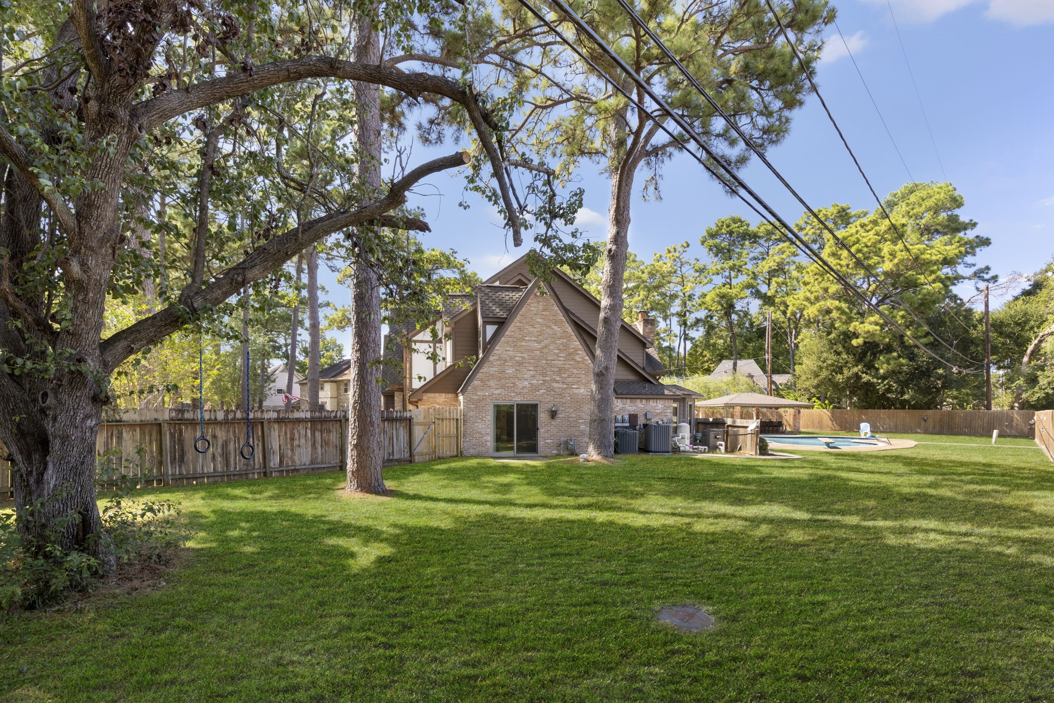 In addition to the pool, basketball court and outdoor kitchen is this massive amount of greenspace for kids and pets to run around.