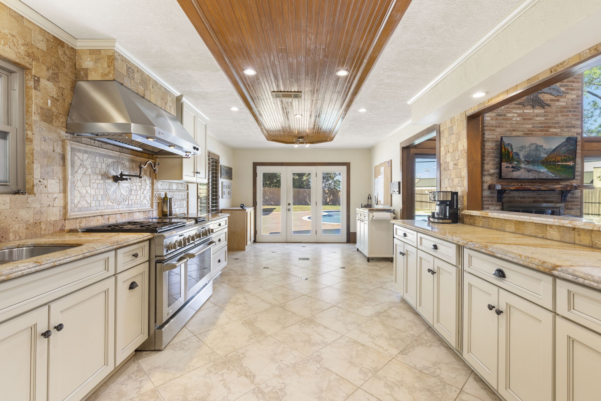 Chef's dream kitchen w/pot filler and GE Monogram professional 48in gas 6-burner + grill oven.