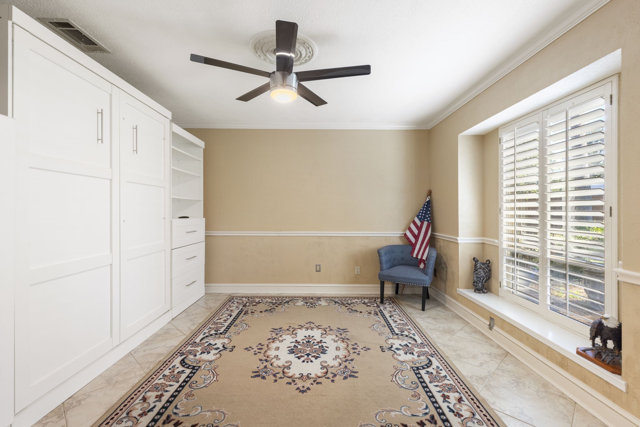 This study overlooks the front yard, has french door access, plantation shutters and extensive Murphy Bed cabinet  built-in making it the perfect home office + space for guests when they come.