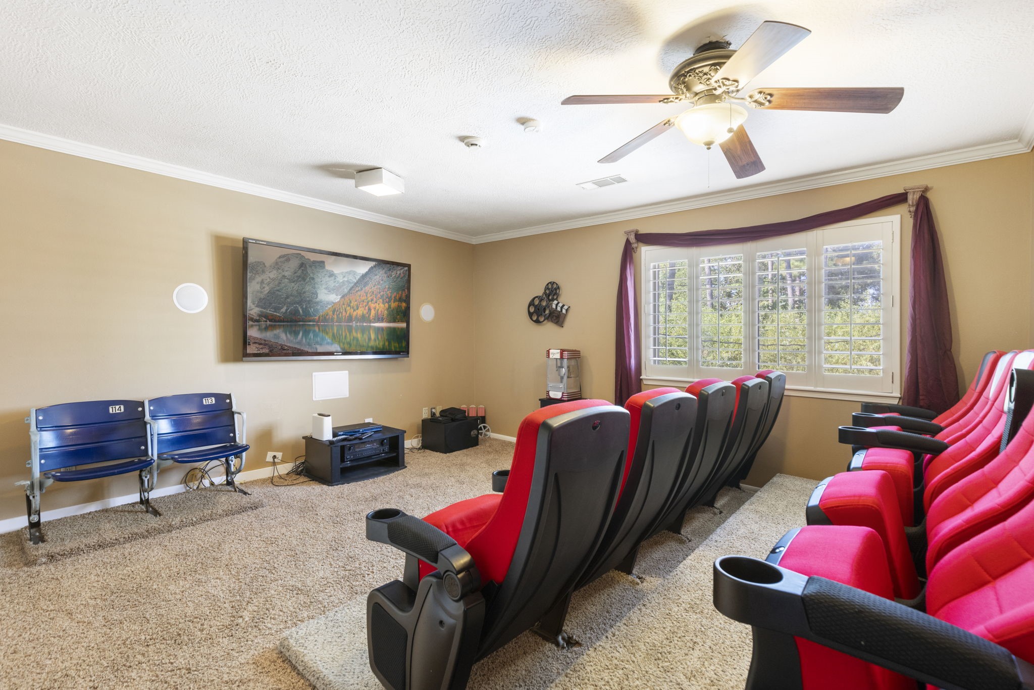 This media room has been upgraded with stadium seating and features a huge closet making it a great 6th bedroom option.