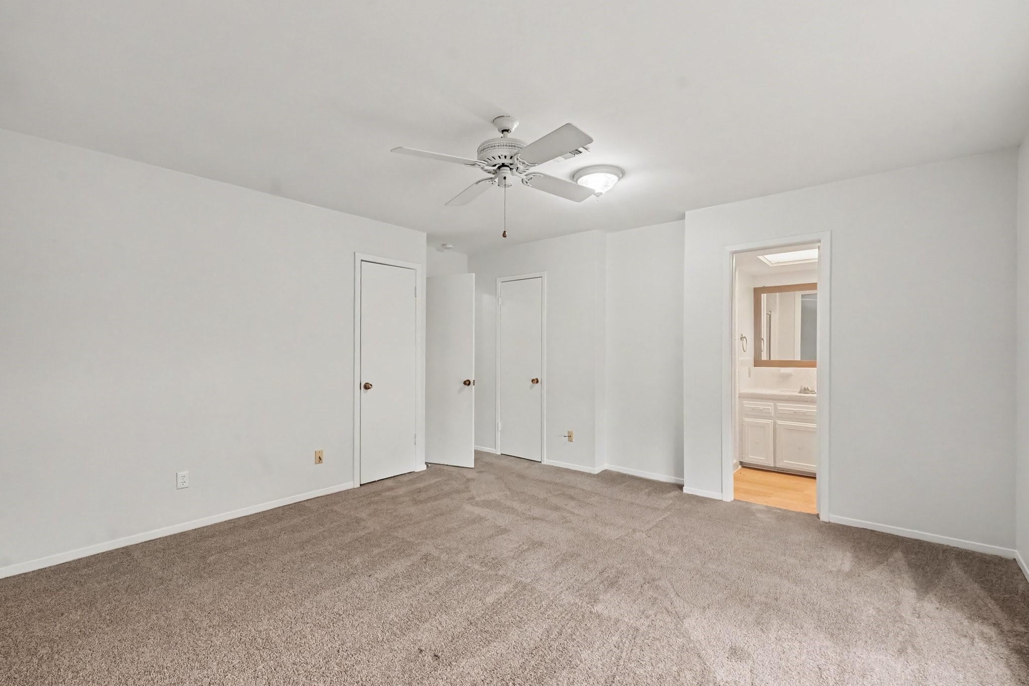 This bedroom offers ample storage space, featuring convenient dual closets.