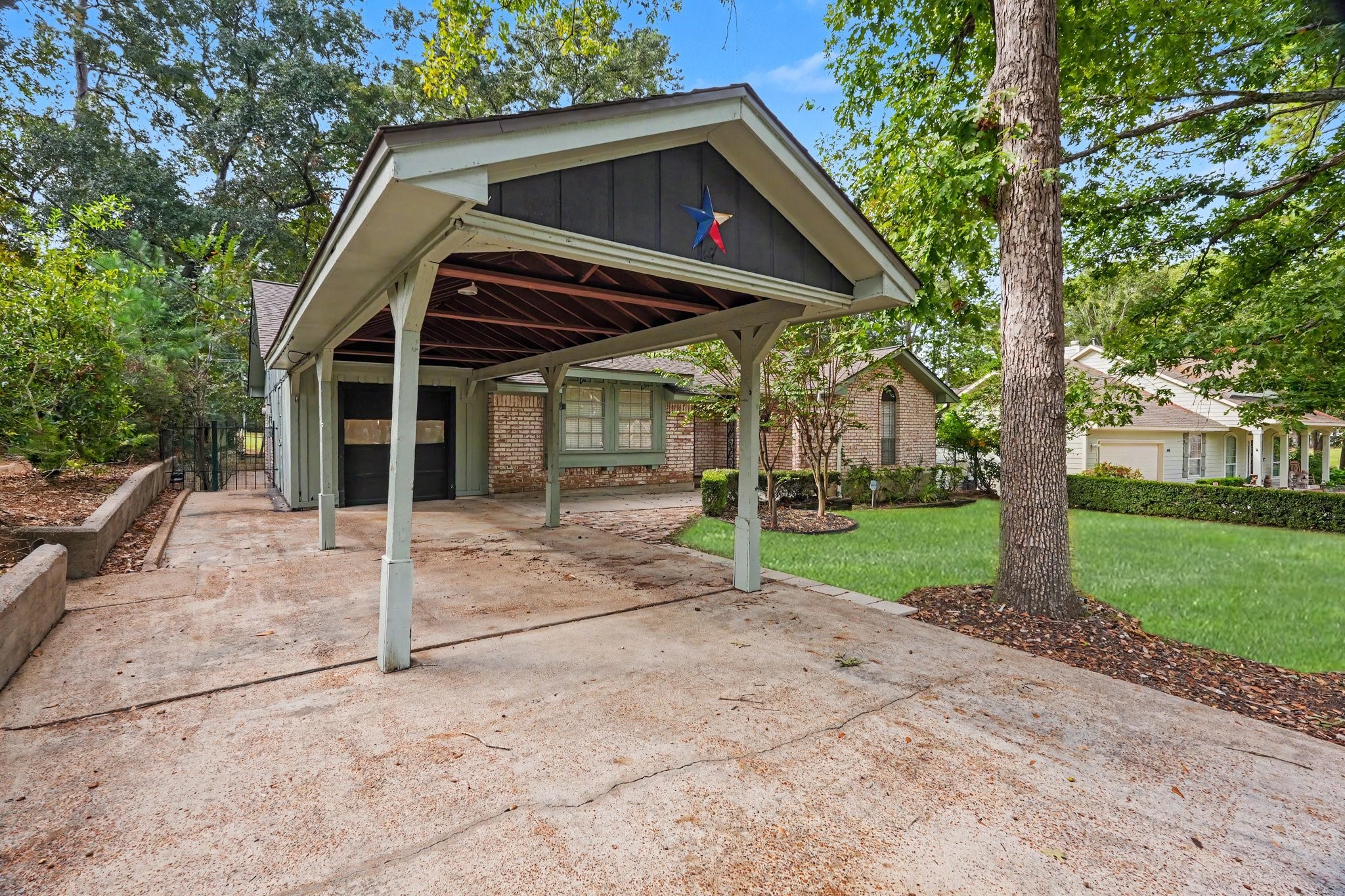 This home features extra side parking for bicycles, golf carts and the like adjacent to the covered space, perfect for accommodating all types of transporation!