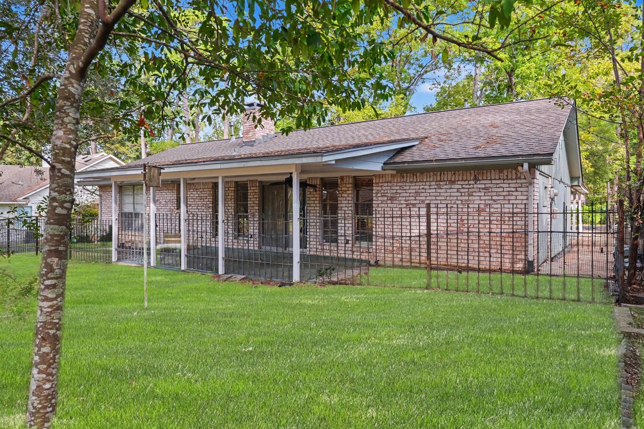 A installed fence creates a private, defined transition between the covered patio and greenspace, providing a seamless buffer from the golf course.