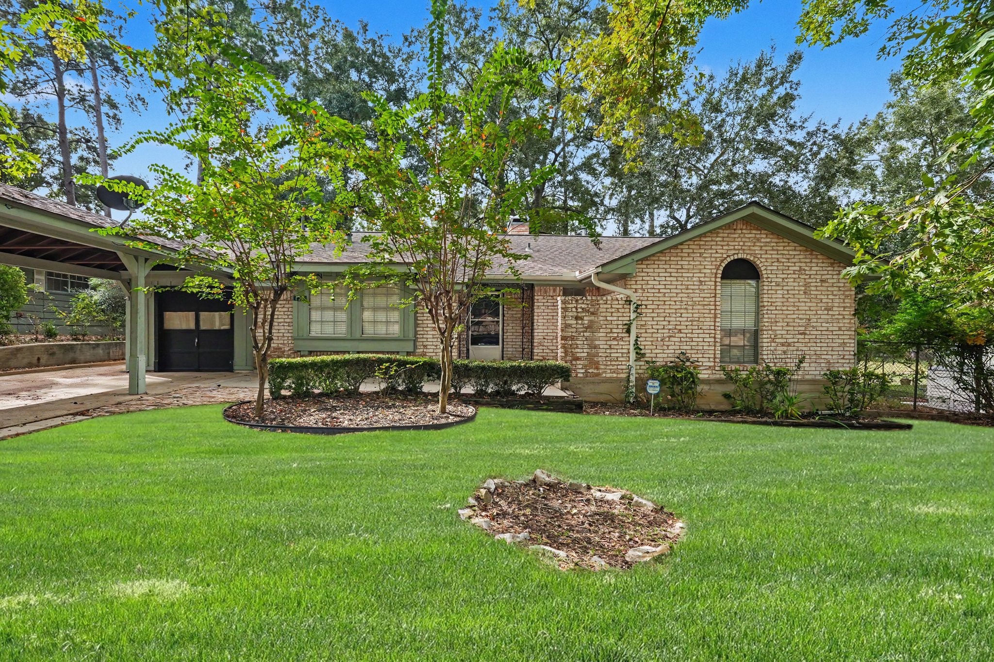 A charming ranch style home awaits you surrounded by mature trees and pretty landscaping!