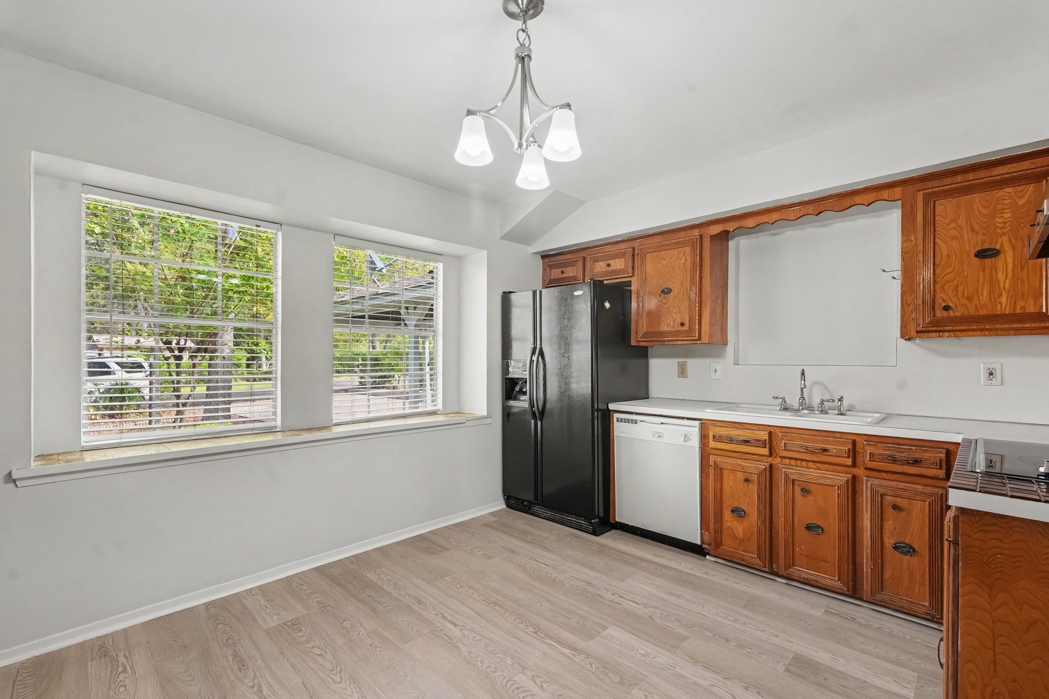 Light and bright kitchen featuring expansive picture windows and a custom ledge for added serving space.