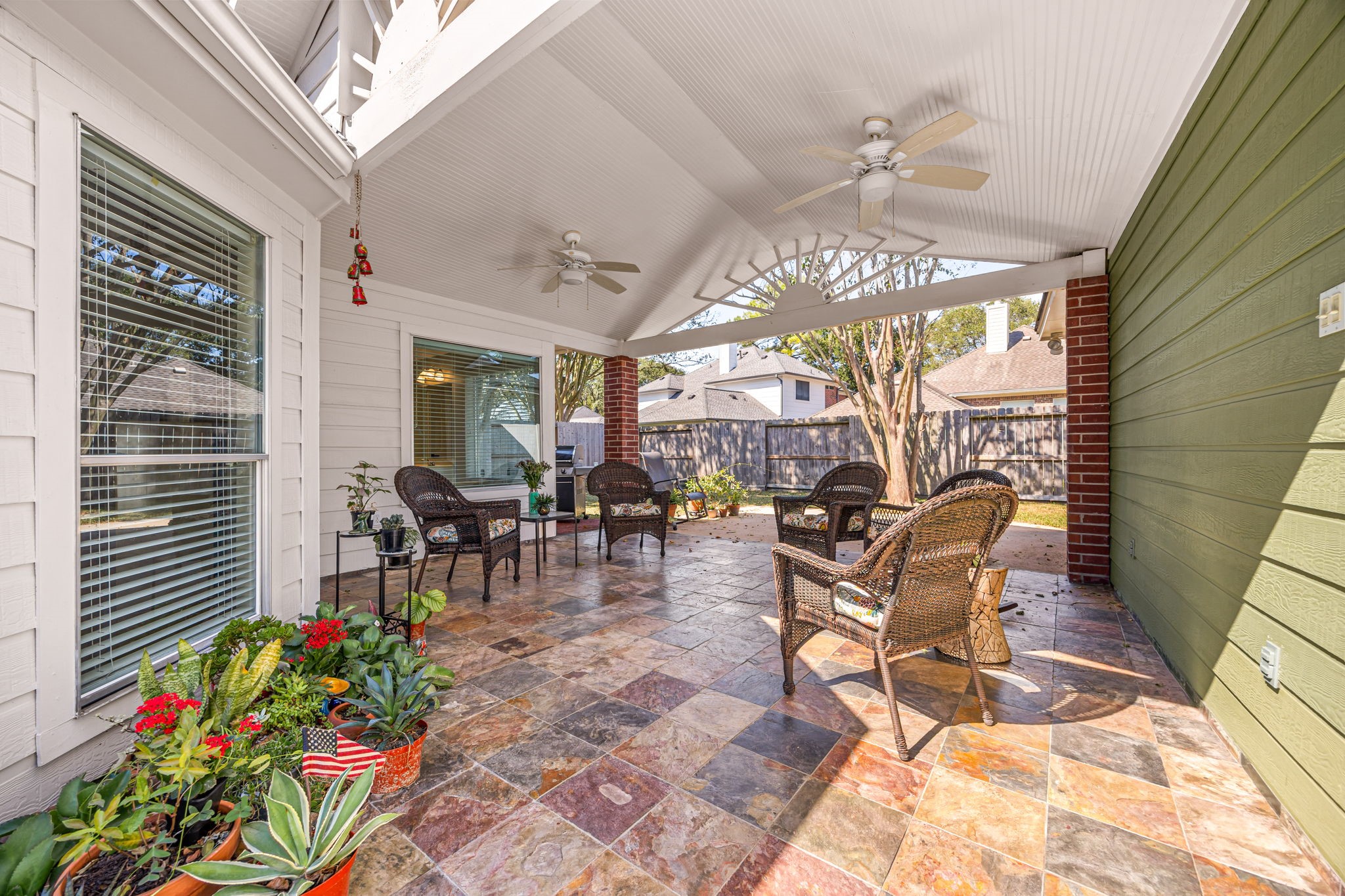 Complete with dual ceiling fans, the covered patio offers the perfect spot to unwind year-round, rain or shine.