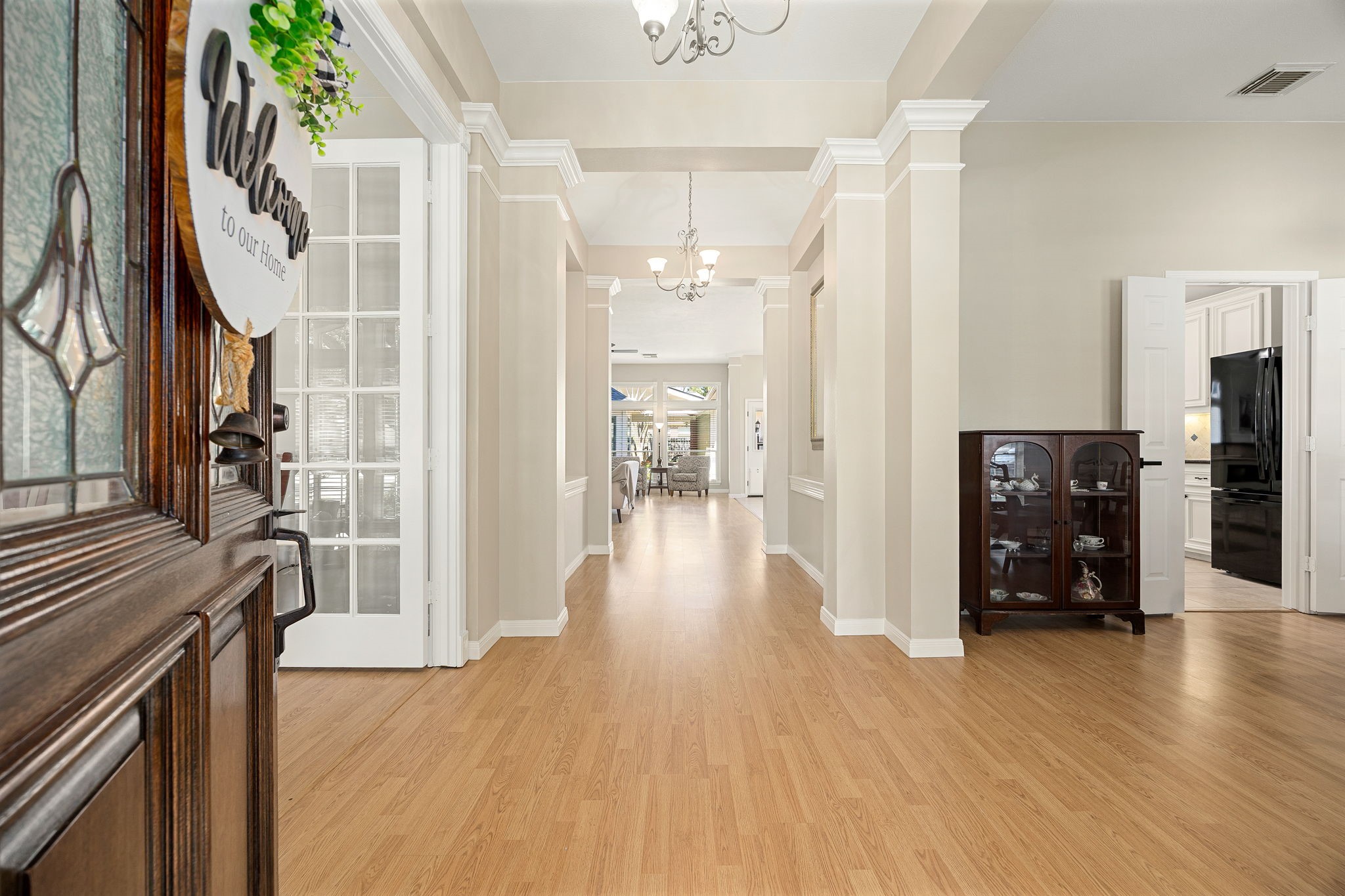 The foyer welcomes you in with rich laminate flooring and an open, airy layout that flows straight through to the main living space. The foyer welcomes you in with rich laminate flooring and an open, airy layout that flows straight through to the main living space.