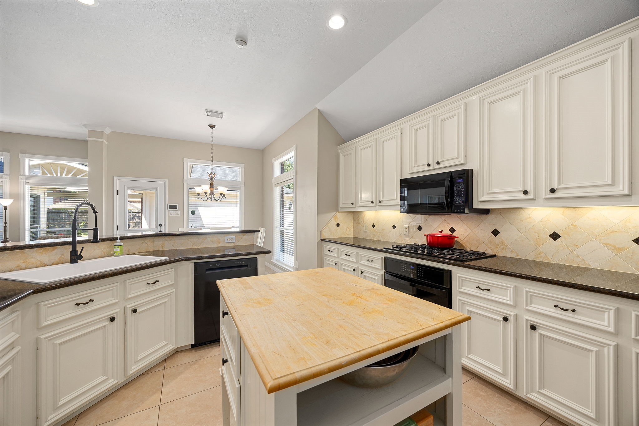 Abundant cabinetry and a butcher block island provide even more workspace and storage in this well-appointed kitchen. Abundant cabinetry and a butcher block island provide even more workspace and storage in this well-appointed kitchen.