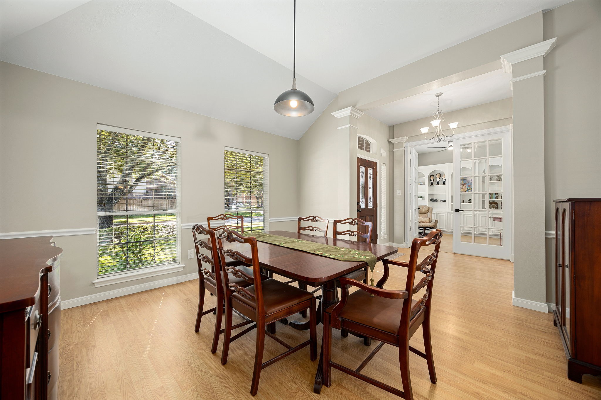 The formal dining area offers plenty of space for entertaining, with a glimpse into the home office beyond, featuring the built-in bookcase. The formal dining area offers plenty of space for entertaining, with a glimpse into the home office beyond, featuring the built-in bookcase.