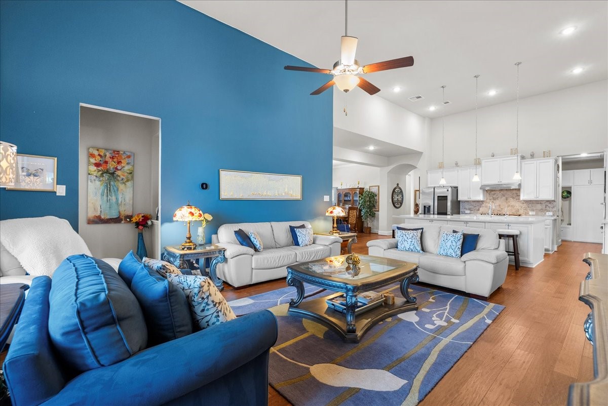 The living room features a cozy fireplace, high ceilings and a wall of windows