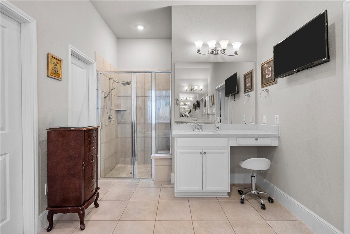 The primary en-suite bath offers dual vanities, a walk-in shower, soaking tub and custom walk-in closet