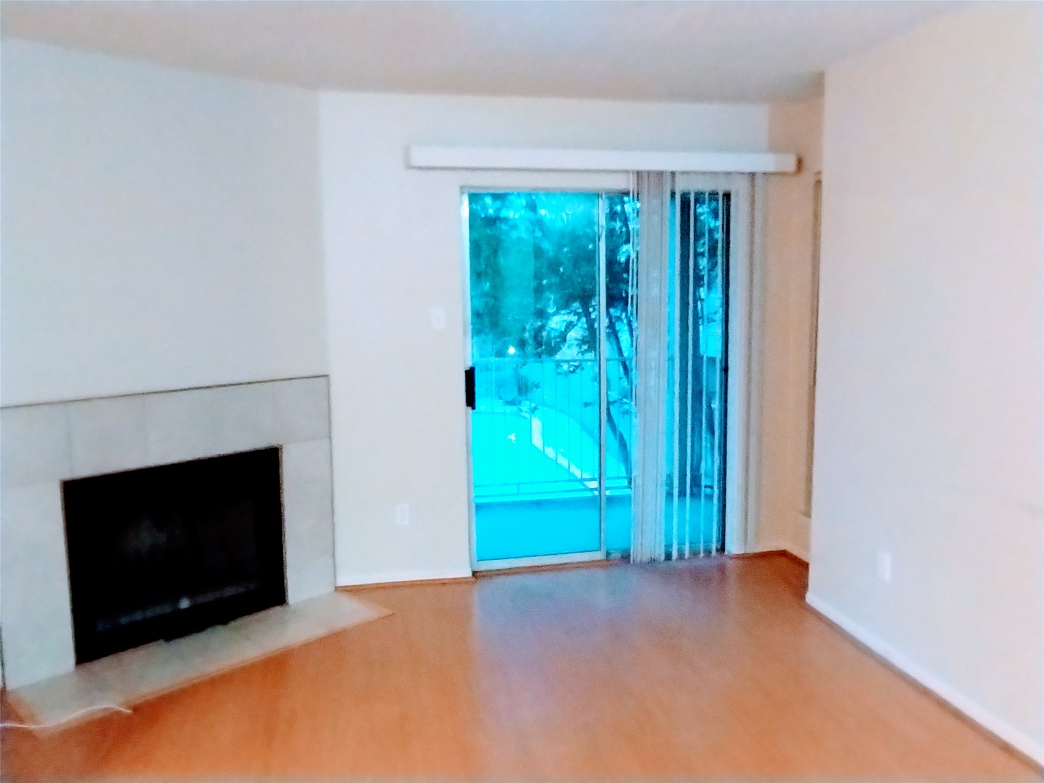 The LIVING ROOM is spacious with generous wall space for furniture placement and your art collection.  The sliding doors open to the Balcony/Terrace that overlooks a beautiful pool and plentiful trees.