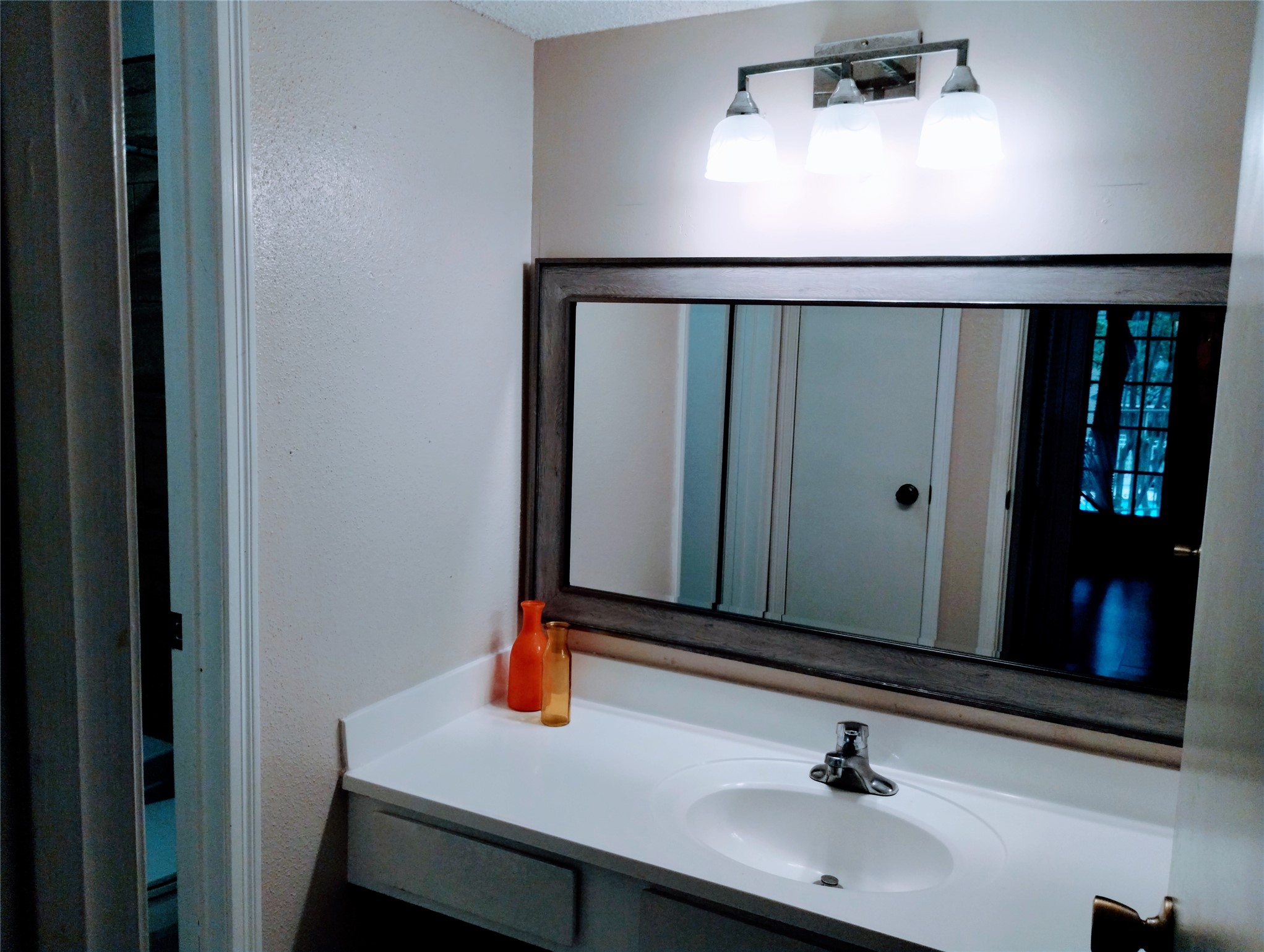 The PRIMARY BATH has a separate sink and vanity.  There is a storage cabinet for towels and linens, and a privacy door that opens to the tub/shower and commode.