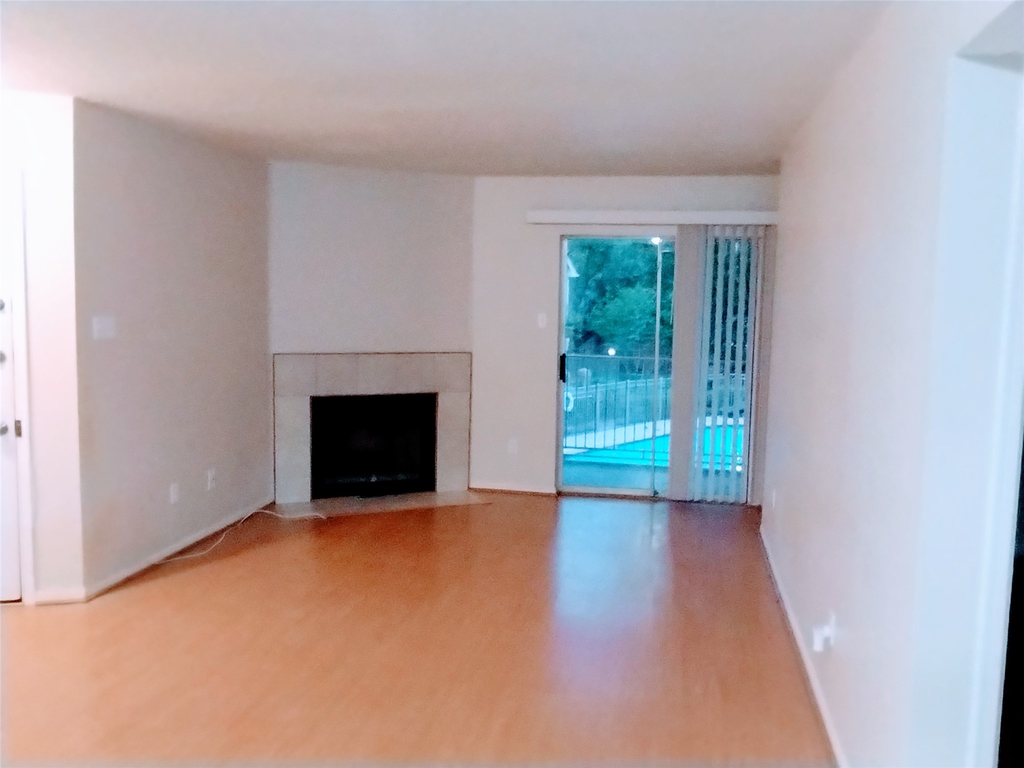 The front door (on the left) opens to a gracious LIVING ROOM with neutral laminate flooring.